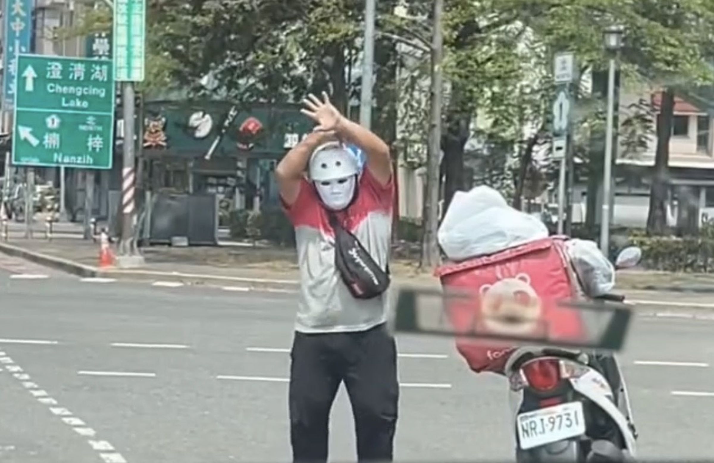 楊姓外送員騎車戴面具，趁停等紅燈時在機車待轉區跳起〈科目三〉。（翻攝畫面）