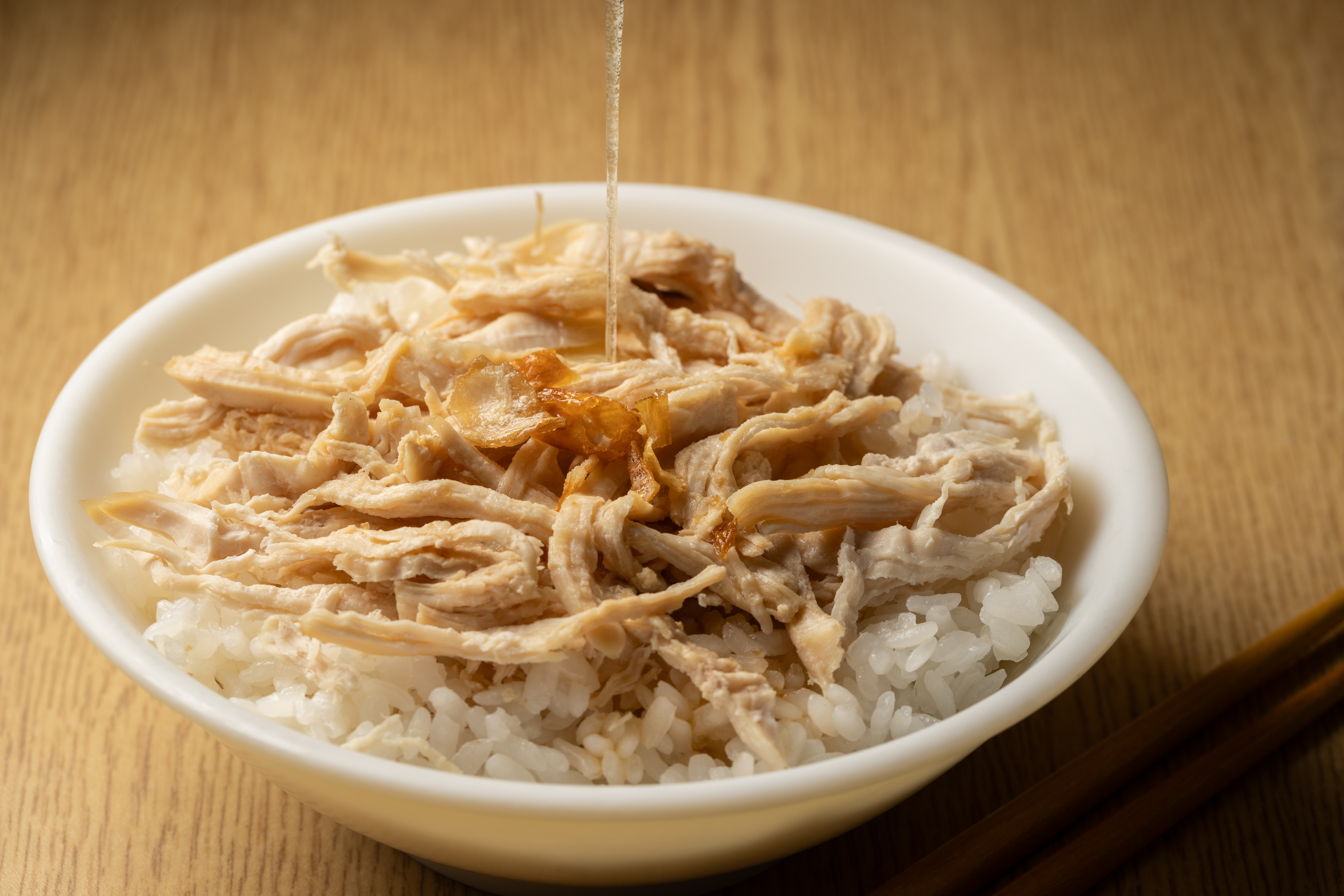 「雞絲飯」淋了雞油和油蔥酥，滋味油潤鹹香。（50元／小碗）