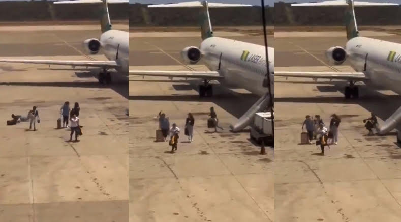 委內瑞拉雷射航空起飛時機身突冒濃煙,乘客被緊急疏散時,竟拖行李箱一起逃生。(翻攝X@Enrique77W)