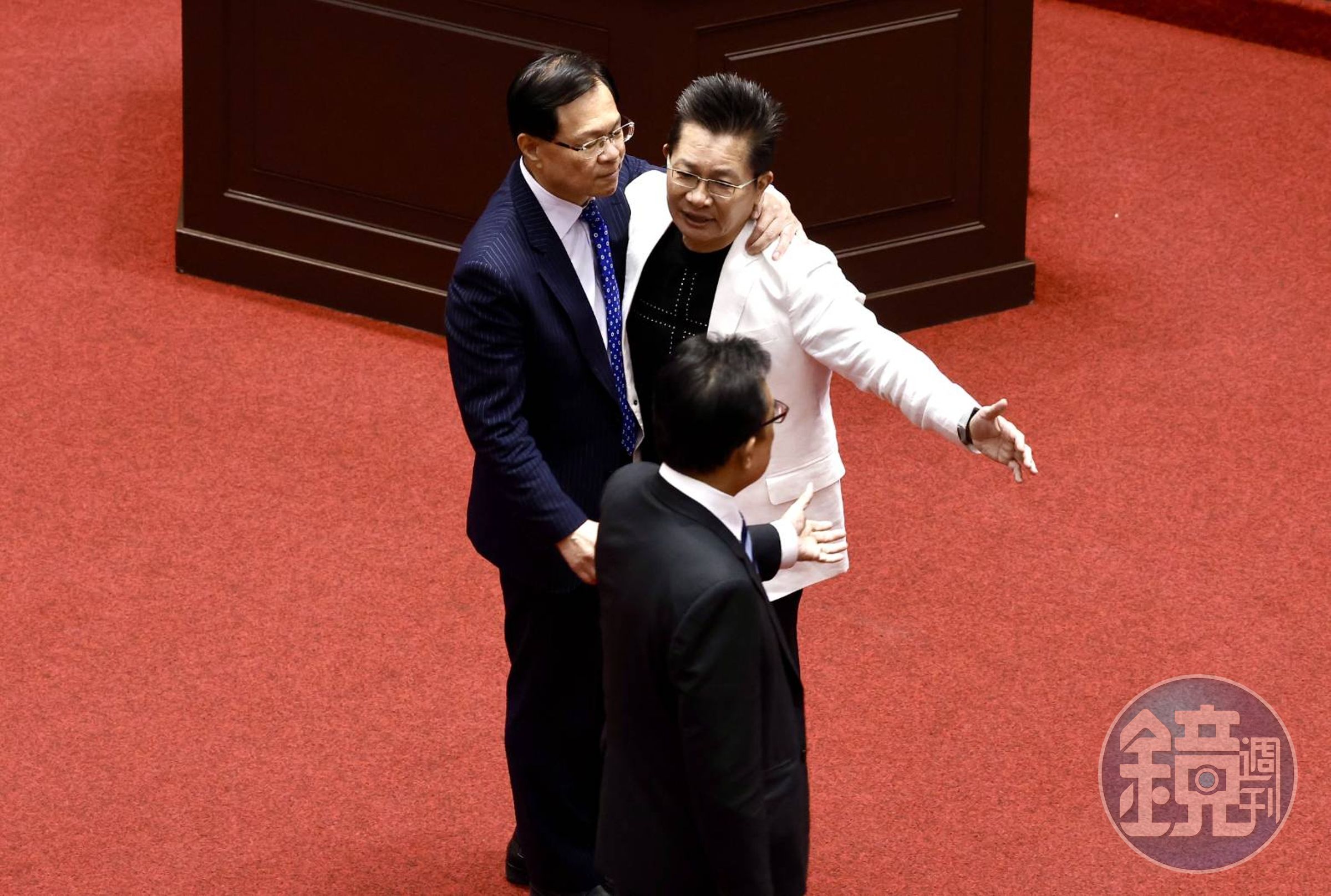 吳春城辭立委，與同黨立委張啓楷擁抱。