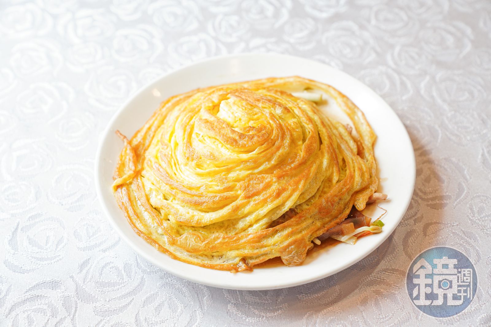 老闆是北平館出身，珍品小館裡的合菜戴帽自然地道。蛋皮底下有什錦菜，頗費工。