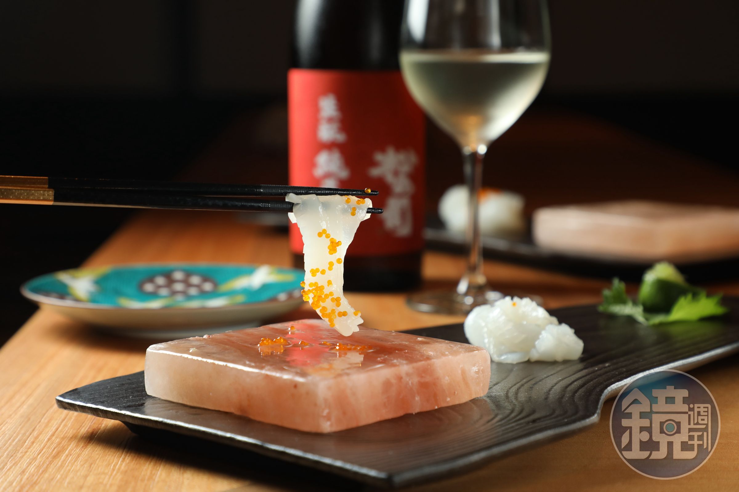 飛翔日料餐廳套餐中的「花枝與飛魚卵刺身」將東港當季花枝切成透光薄片，夾起後在抹過檸檬片的喜馬拉雅岩鹽板上輕涮數次，吃法十分有儀式感。（午、晚間套餐菜色）
