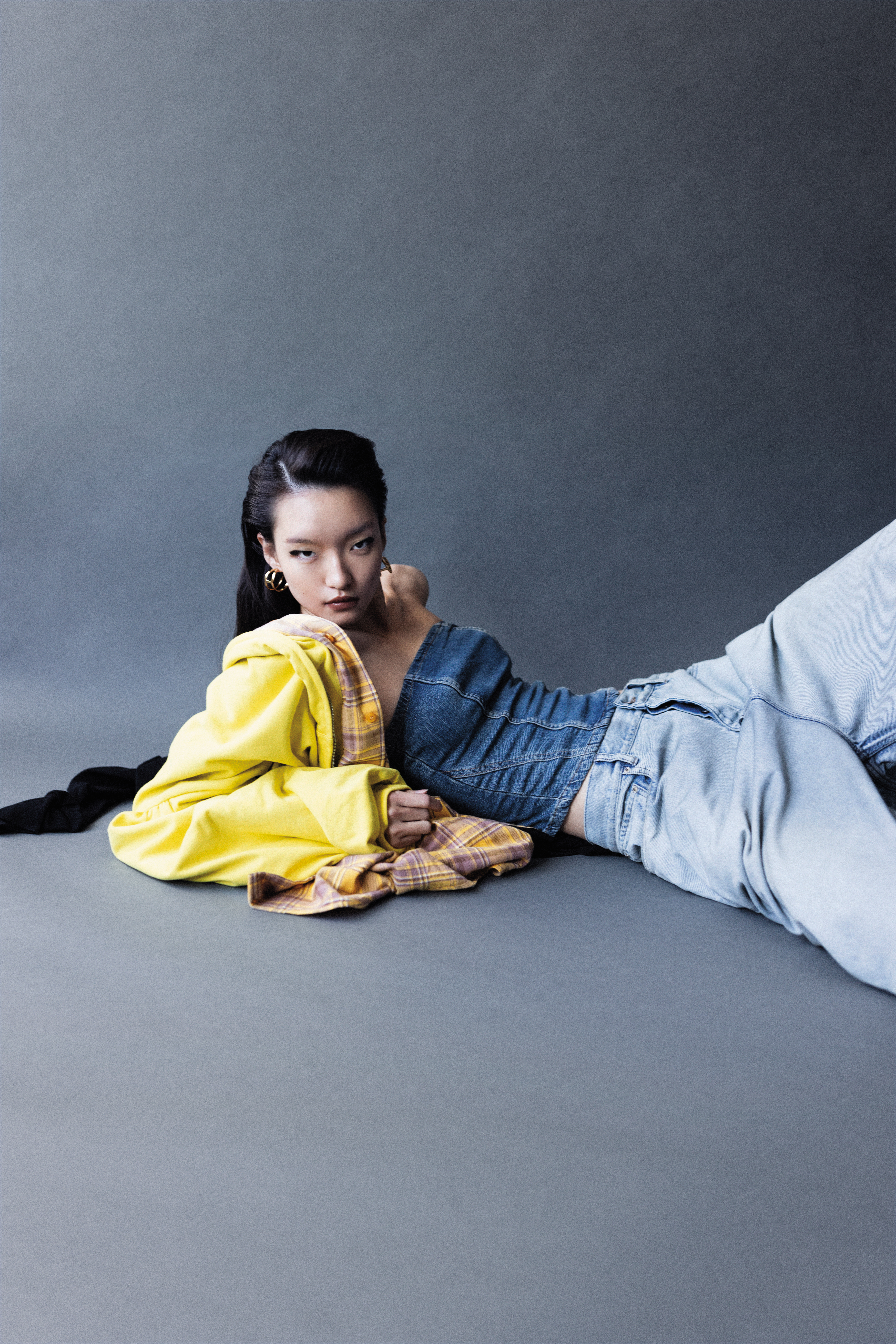 黃色棉質拼接夾克 NT$134,400 by BALENCIAGA；丹寧平口上衣 NT$650 by ZARA；丹寧長褲 NT$50,000 by BALENCIAGA；Marcie圓形耳環 NT$19,500 by Chloé。