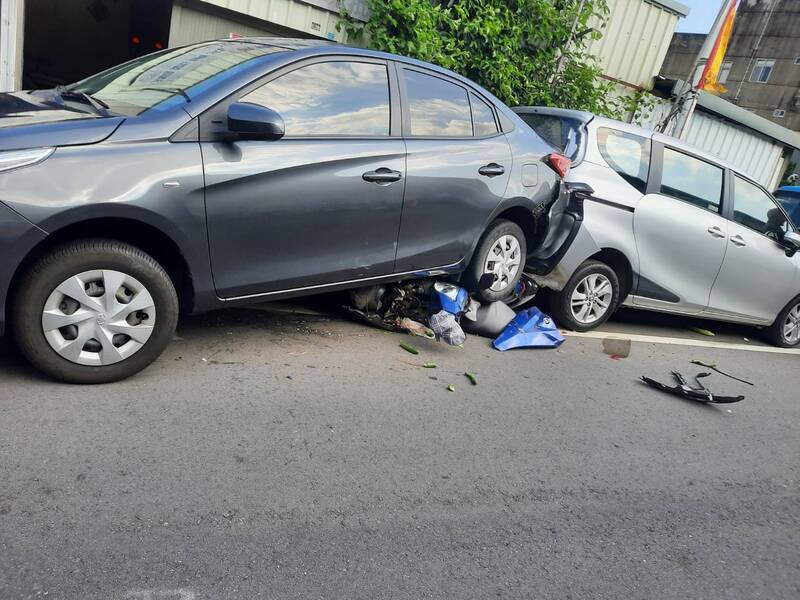 謝姓老翁今日在苗栗縣通霄鎮疑似打錯檔，猛力倒車撞倒沈姓女騎士，沈婦的機車整個被壓在轎車底盤成了廢鐵。（翻攝畫面）