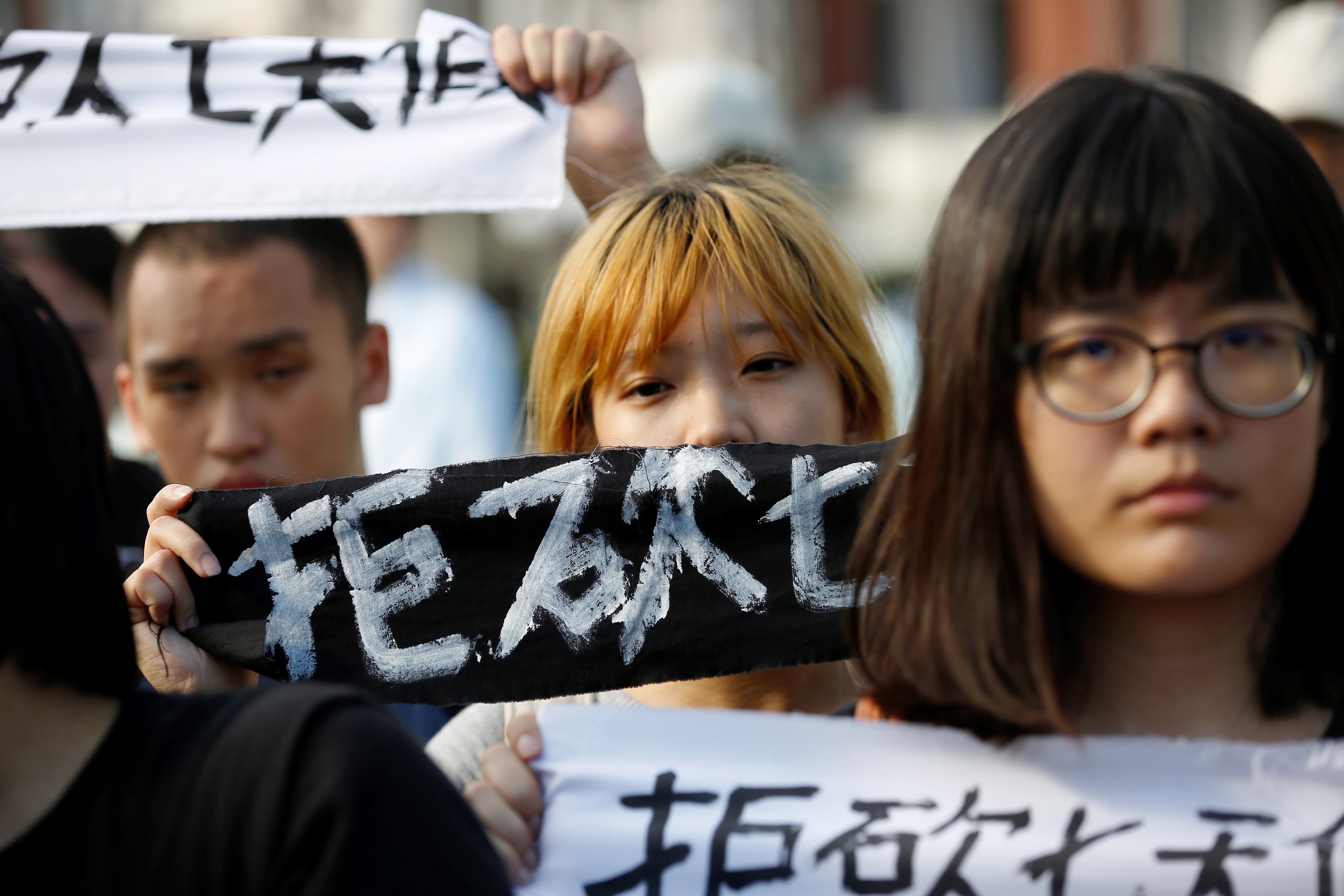 抗議學生舉著拒砍7天假標語。