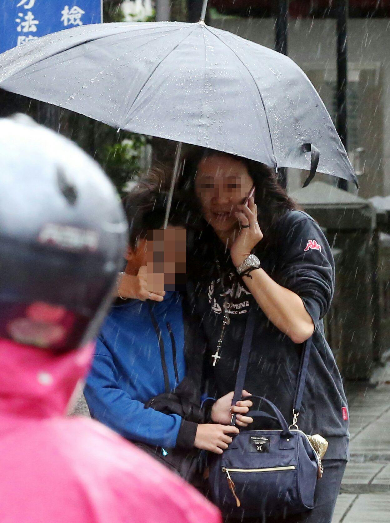 李姓超跑業務元配擔心孩子淋雨著涼,還貼心地替孩子撐傘。