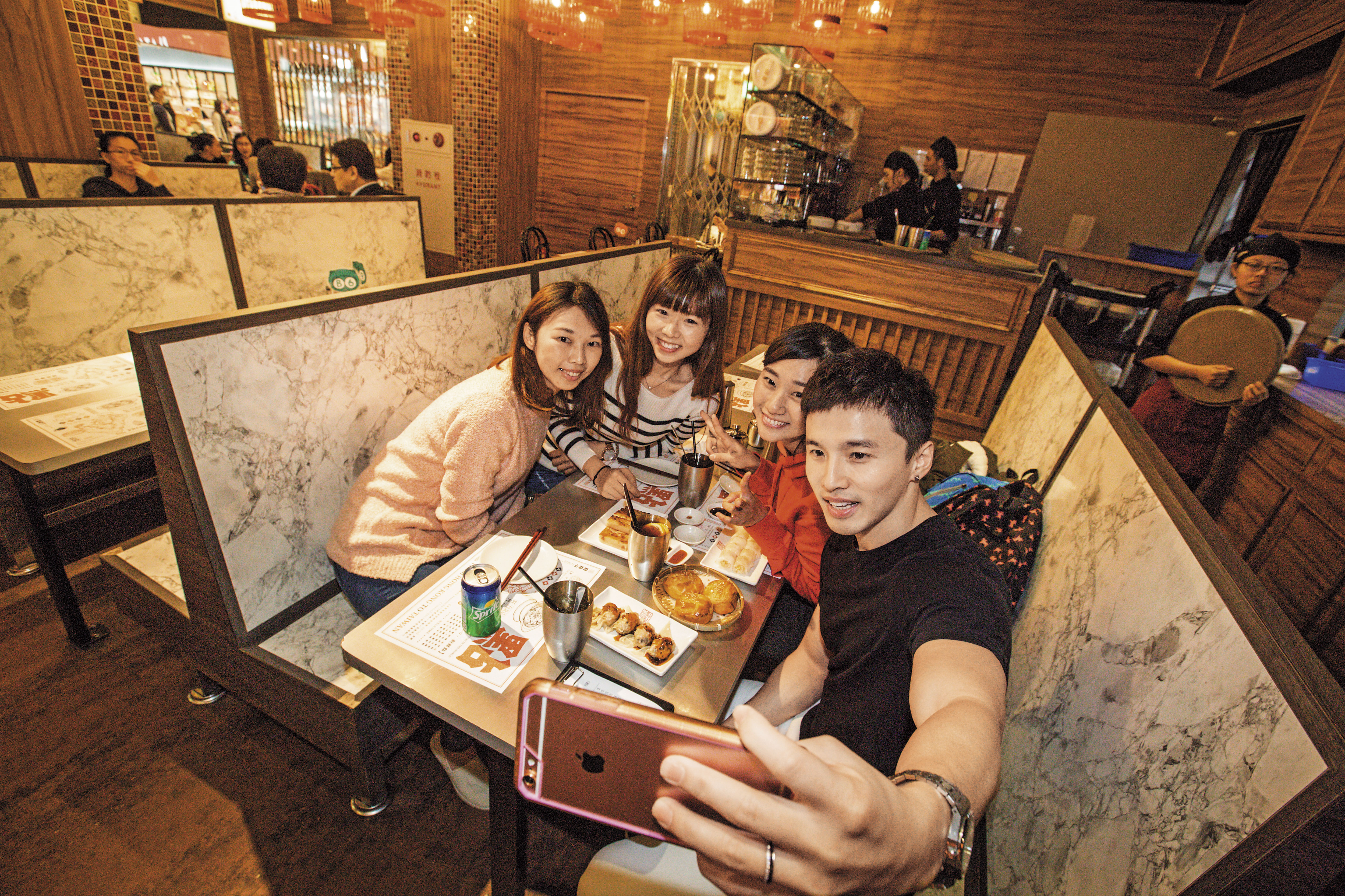 餐廳客人若遇見阿緯（右 1）巡店，常會主動要求合照。