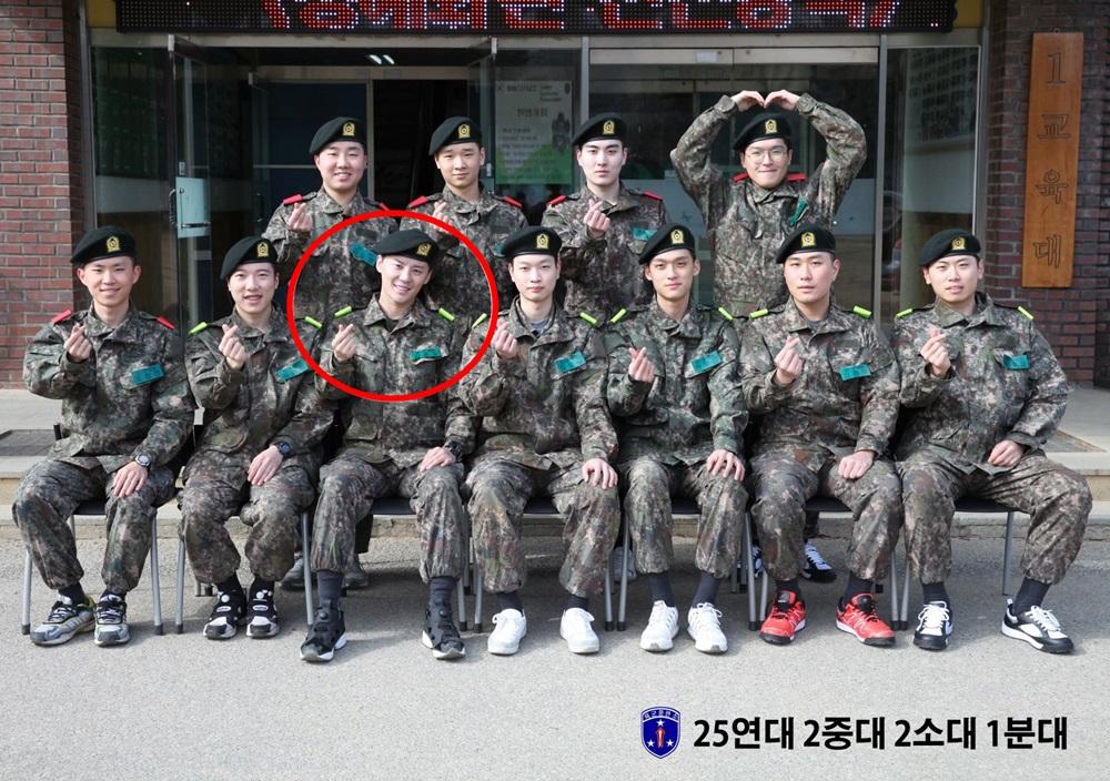 金俊秀（紅圈者）與新兵合照，輕鬆神情加上愛心手勢，看來頗適應軍隊生活。（網路圖片）