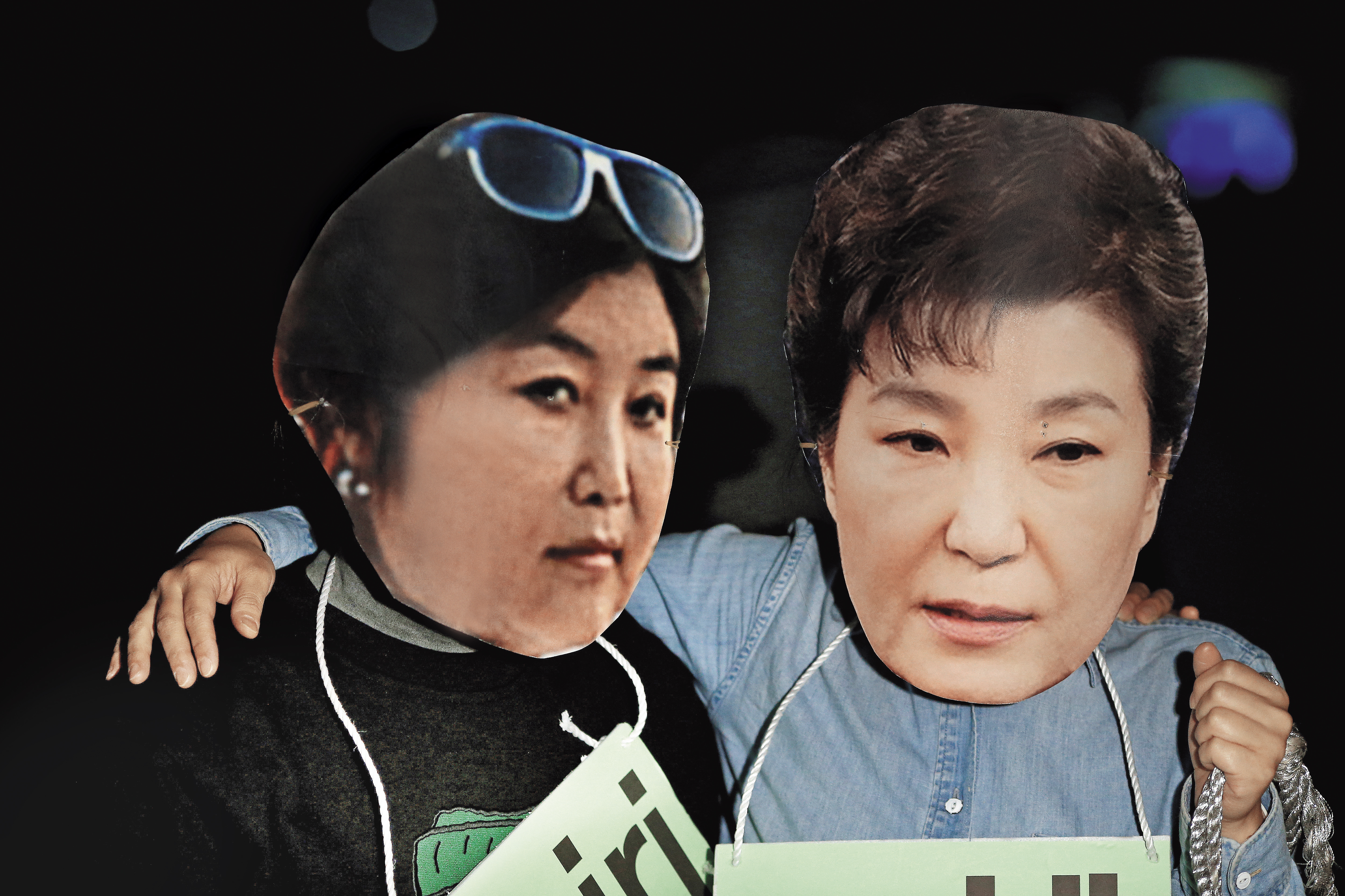 無公職身分的朴槿惠「親信」崔順實,干涉國政的醜聞令南韓政壇震動。抗議民眾戴上崔順實(左)、朴槿惠(右)頭像嘲諷。(達志影像)