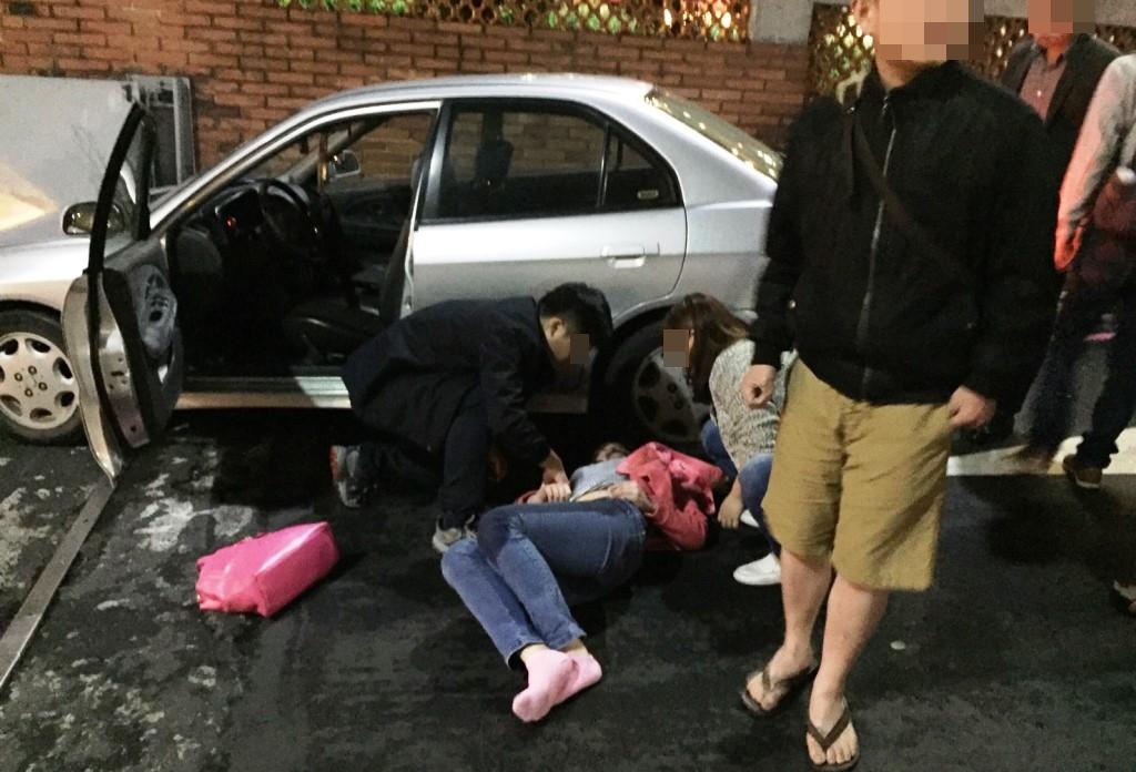路人見林女上半身遭輾、失去意識，立即合力抬車協助脫困。