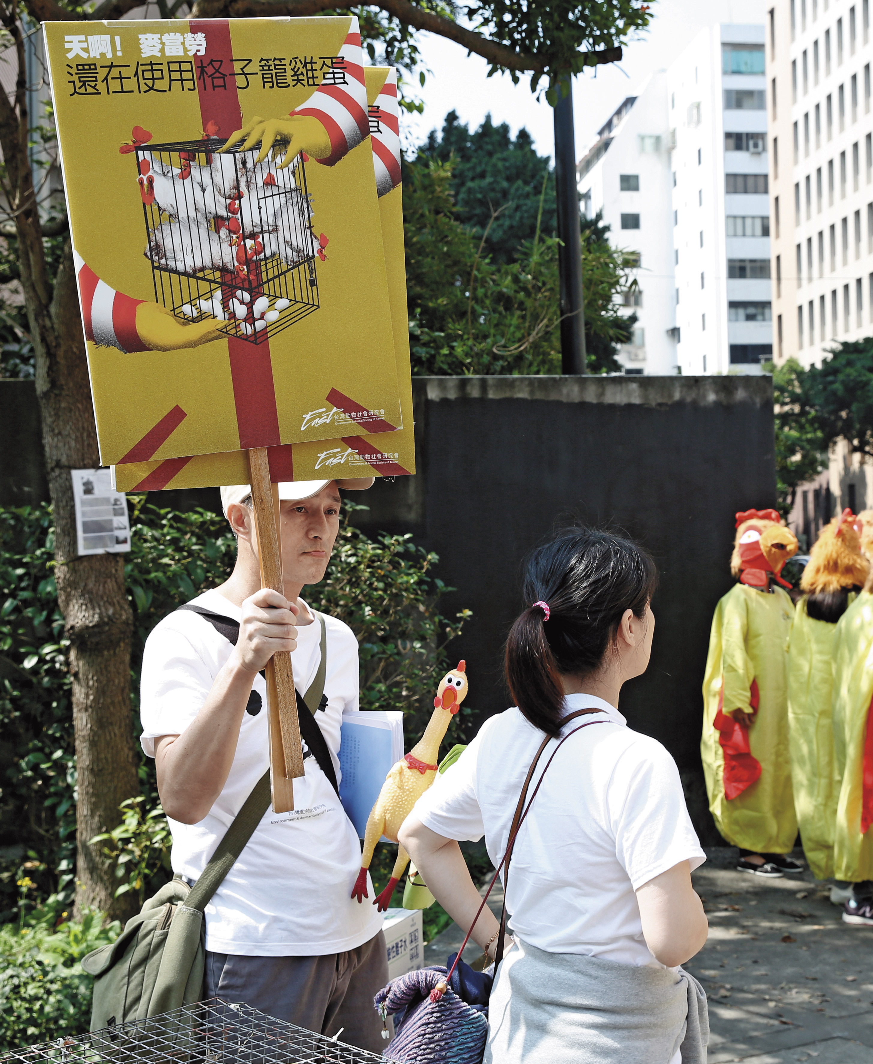 在抗議麥當勞使用格子籠雞蛋的行動中,朱增宏(左)像個工讀生負責發新聞稿、舉牌。