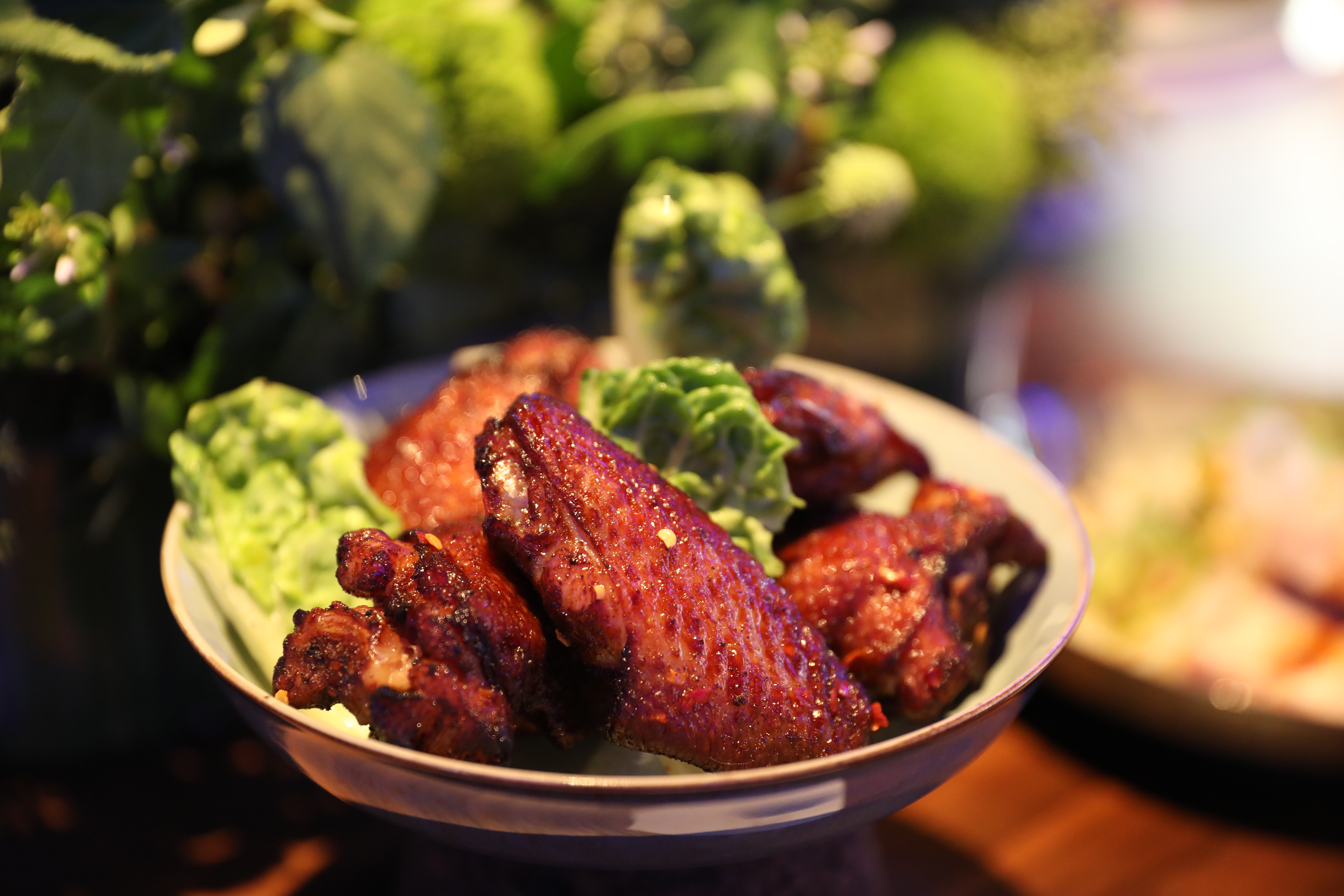 「脆皮南風雞翅」以白味噌、酸奶、白酒、檸檬汁醃製入味，搭配剝皮辣椒醬，十分下酒。（250元／份）