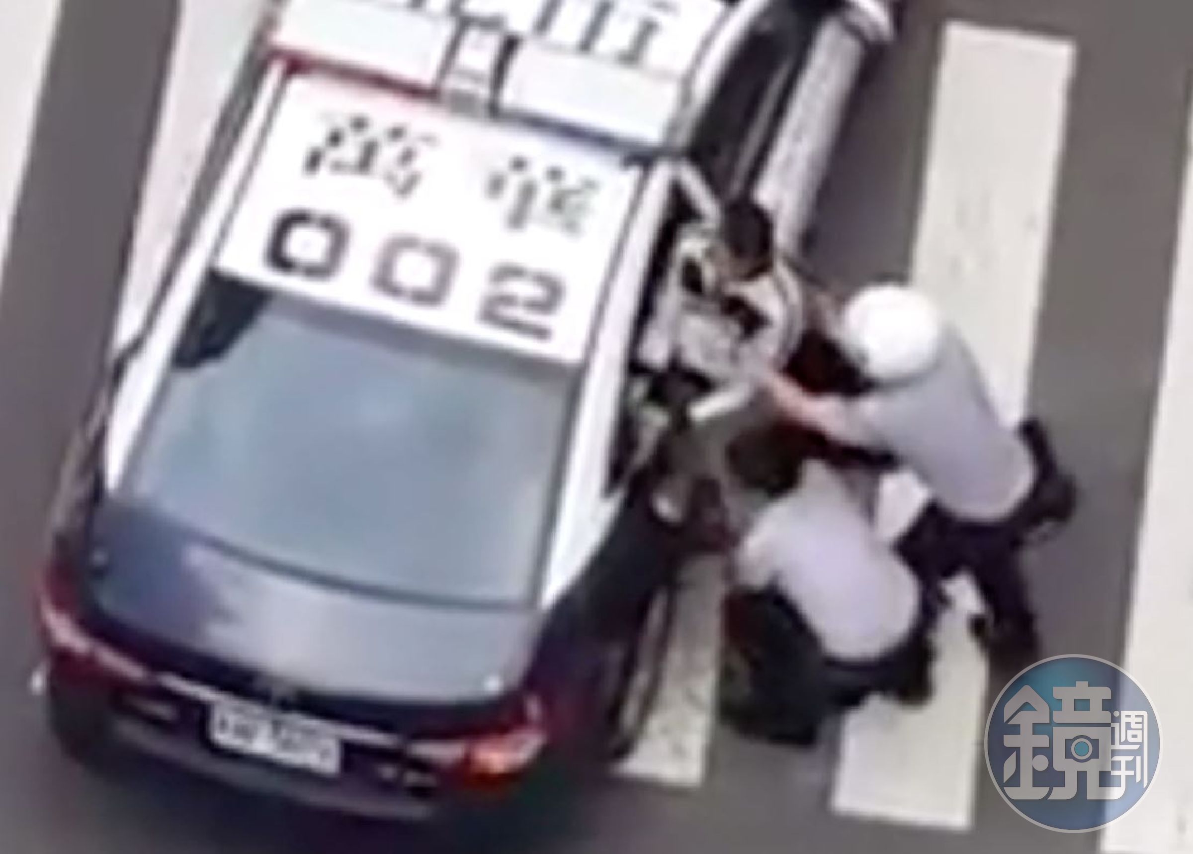 男子抵死不上車，員警最後只好合力將他抬起，塞入車內。