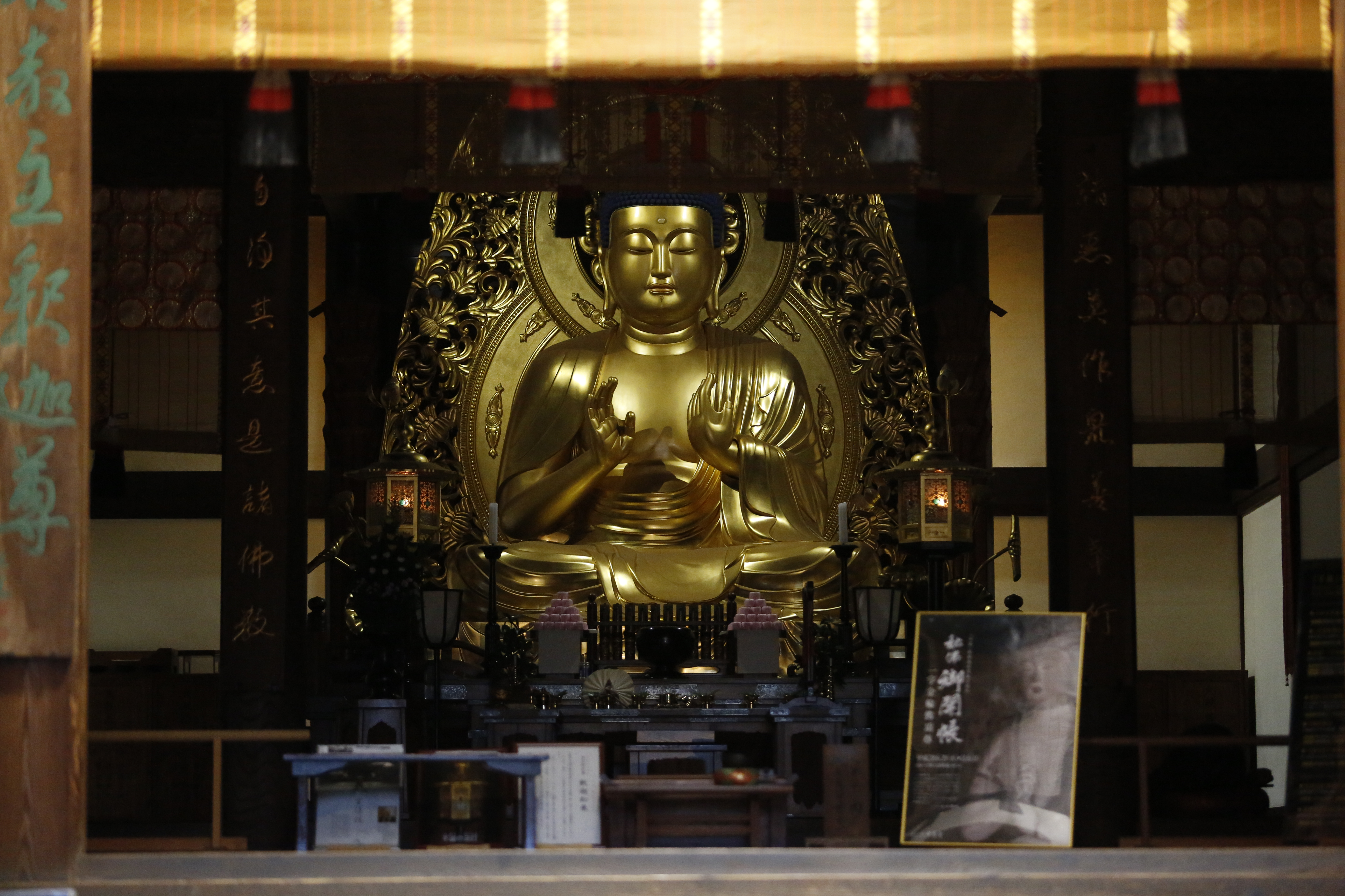 中尊寺本堂的阿彌陀佛像莊嚴祥和，兩旁的不滅法燈隨側守護。