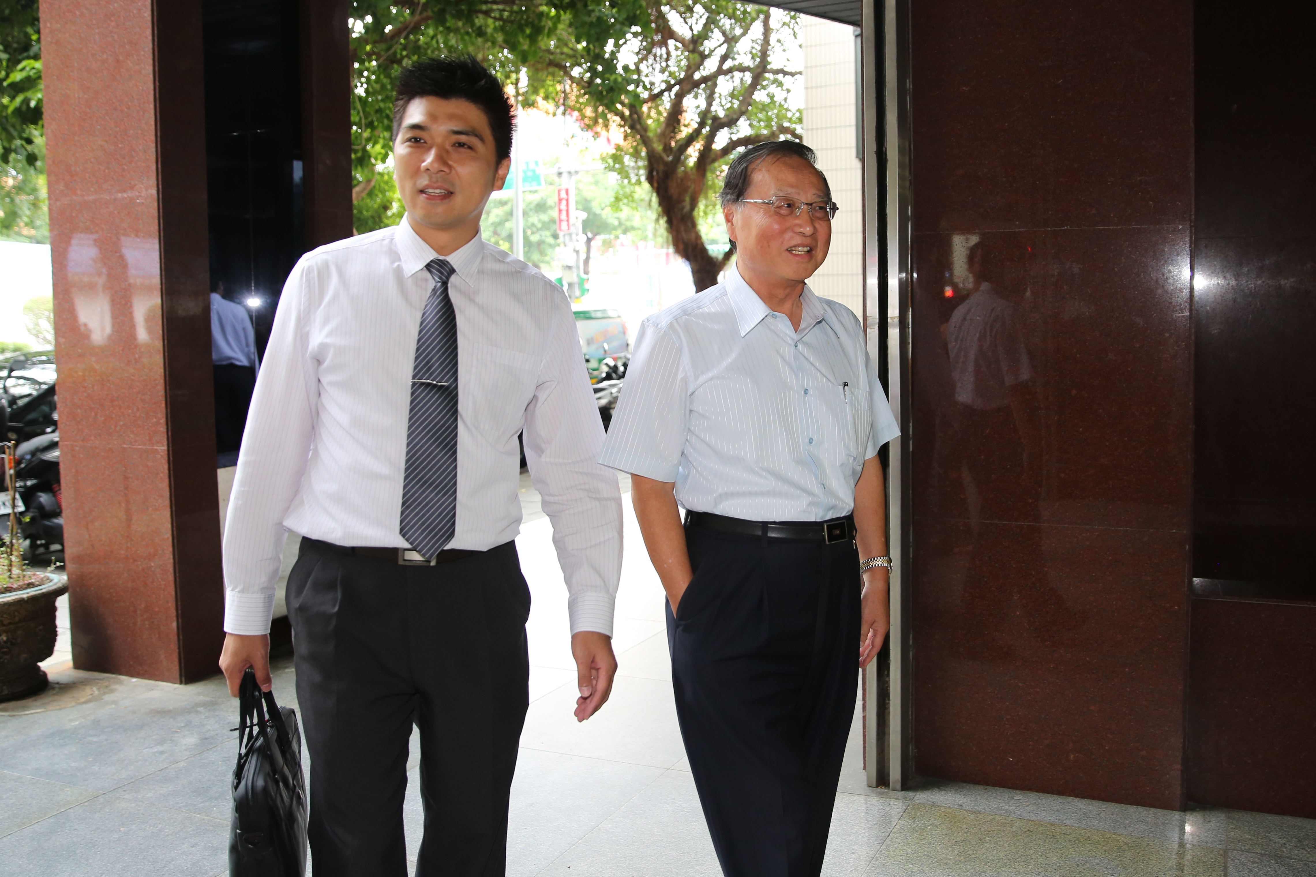 國民黨前行管會主委張哲琛（右）因涉及賤賣黨產，3日上午赴北檢說明案情。
