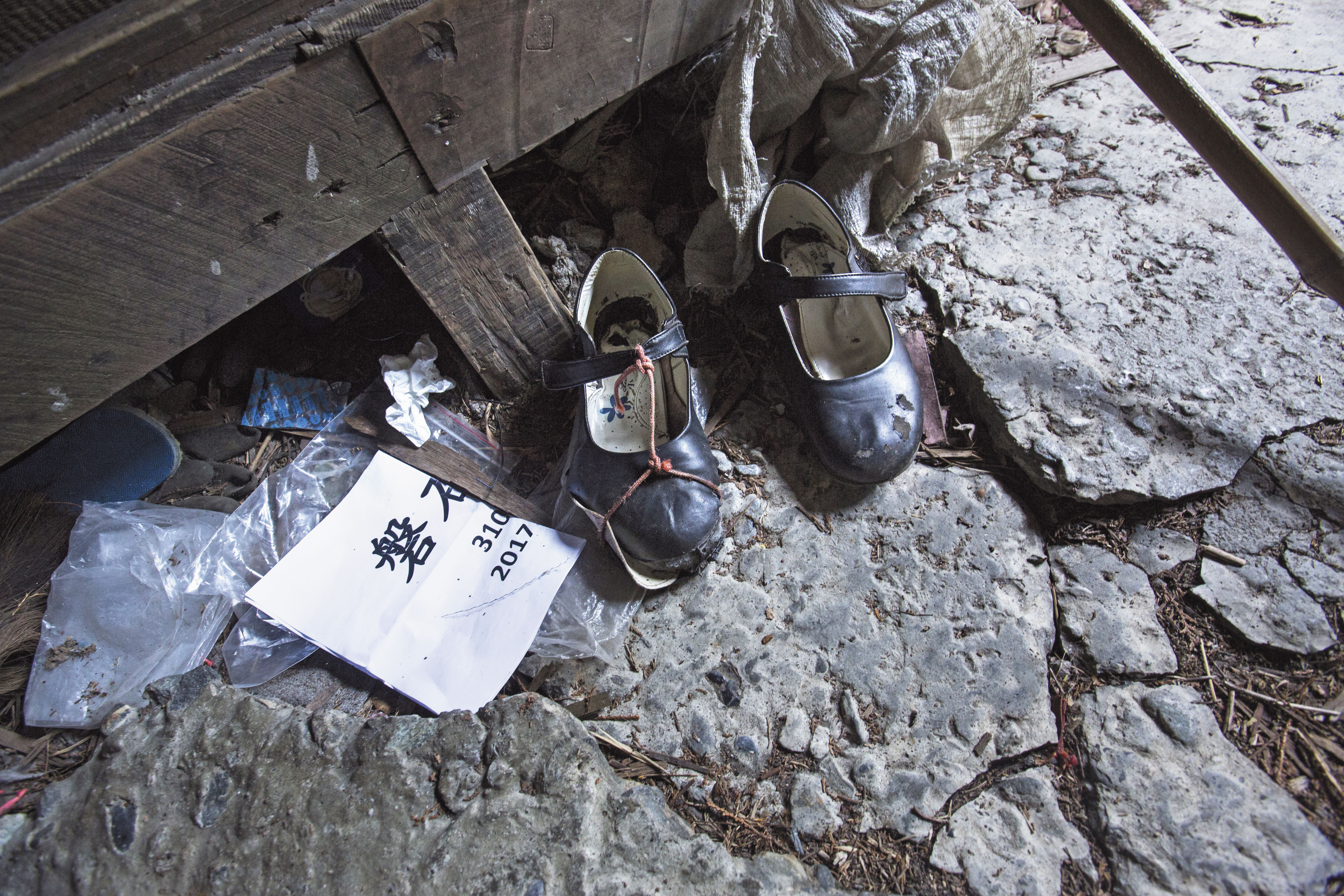 雪娃穿著簡便的娃娃鞋登山，才上山，鞋子就壞了。壞掉的娃娃鞋留在12K工寮，紅色帶子是雪娃自己綁的。她在山上基地留了雨鞋，便換穿下山。