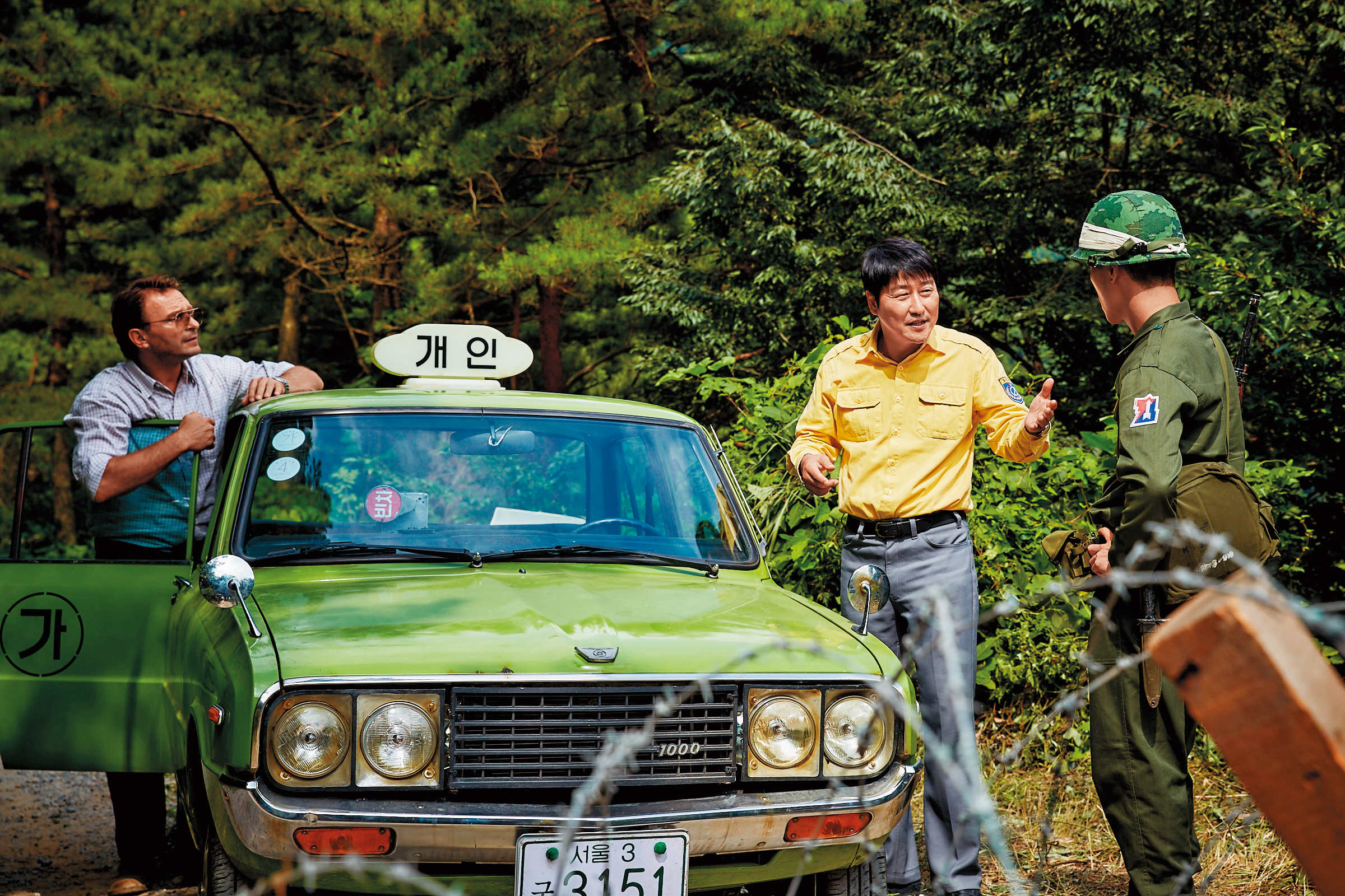 韓片《我只是個計程車司機》由宋康昊（中）、湯瑪斯柯瑞奇曼（左）主演，從各種角度深刻描繪人性，打動人心。 （車庫娛樂提供）