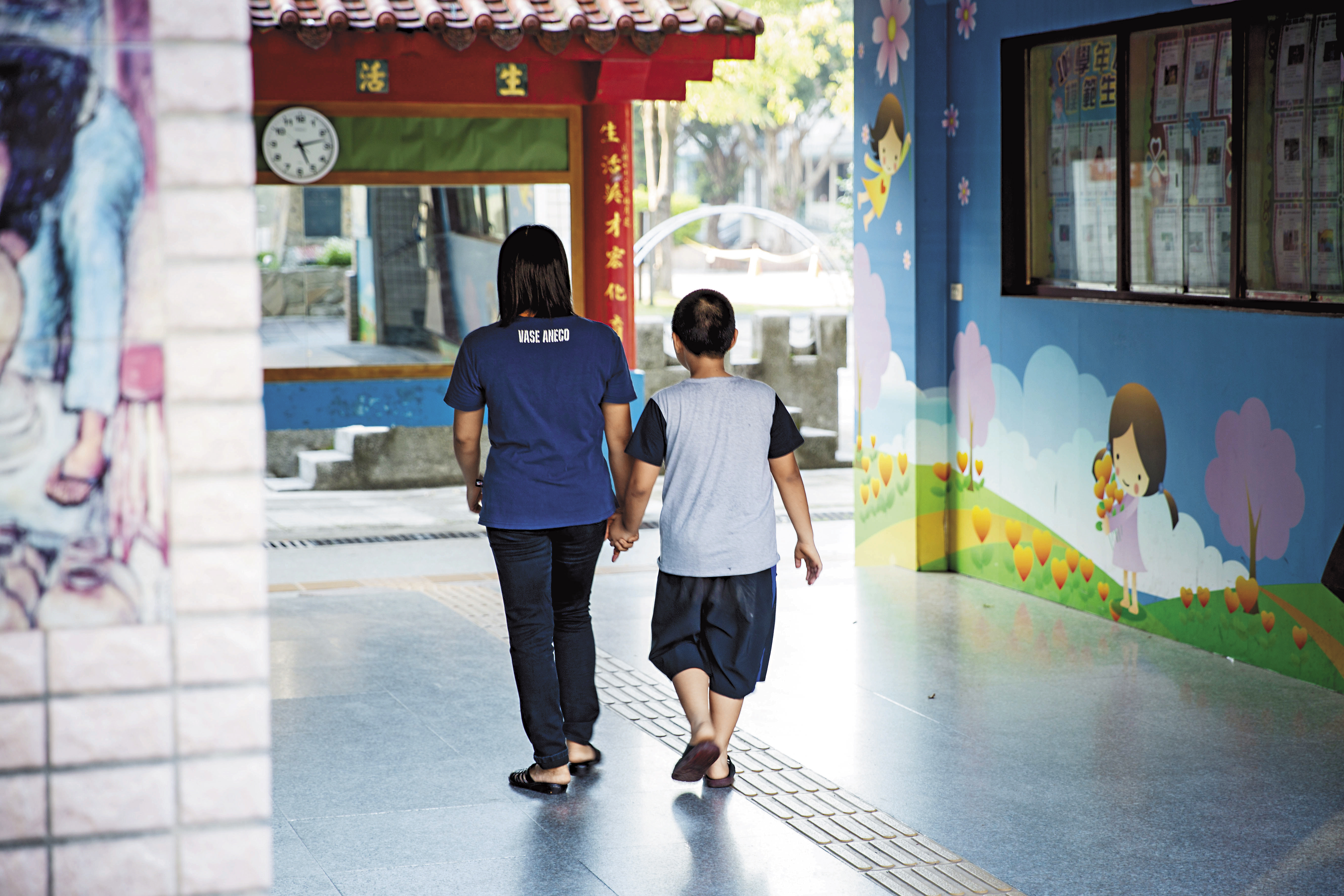 小寶緊緊牽著母親阿拚的手，希望可以在台灣好好過日子。