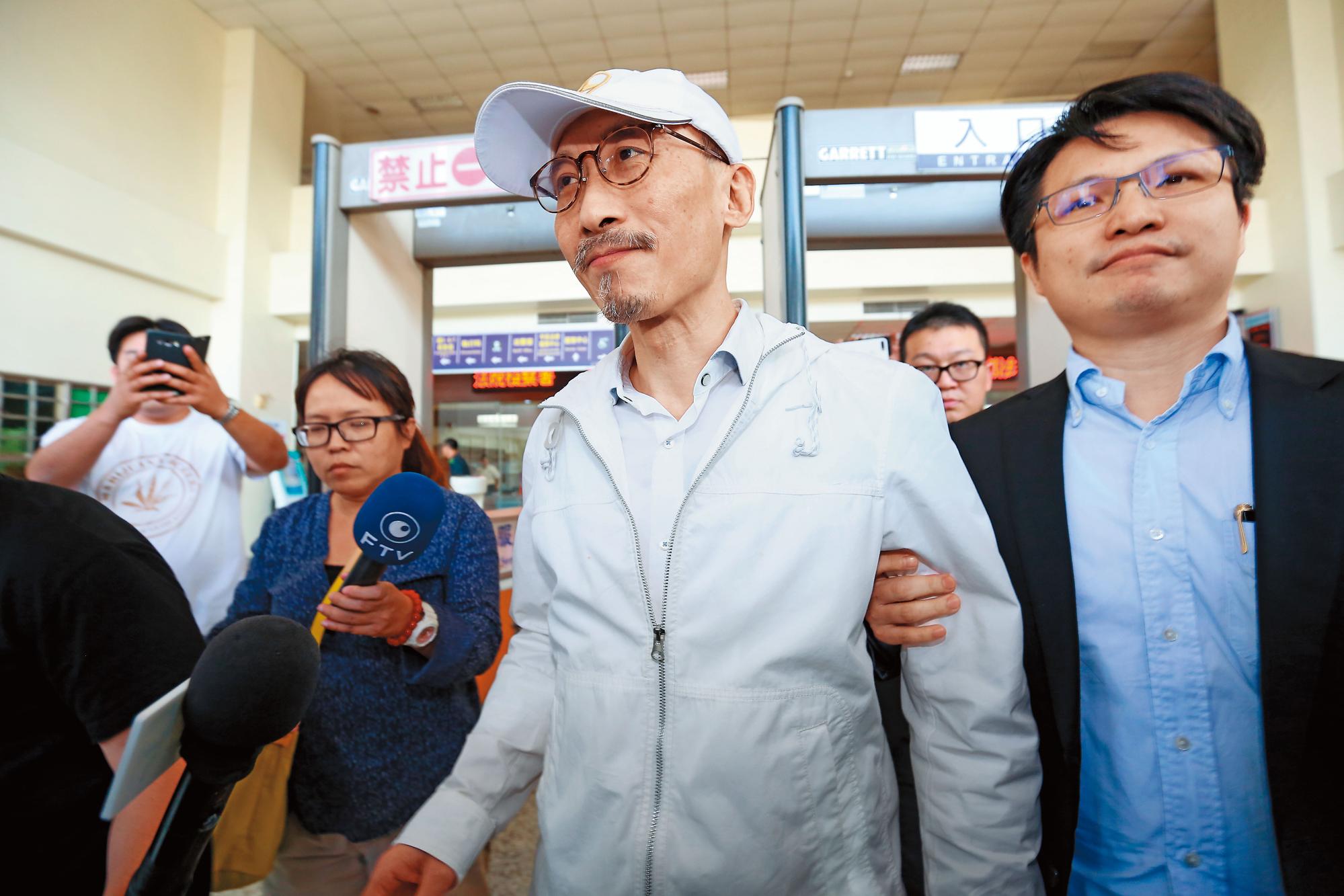 江欽良（前左）迅速籌出千萬元現金，獲得交保，在律師陪同下步出地檢署。