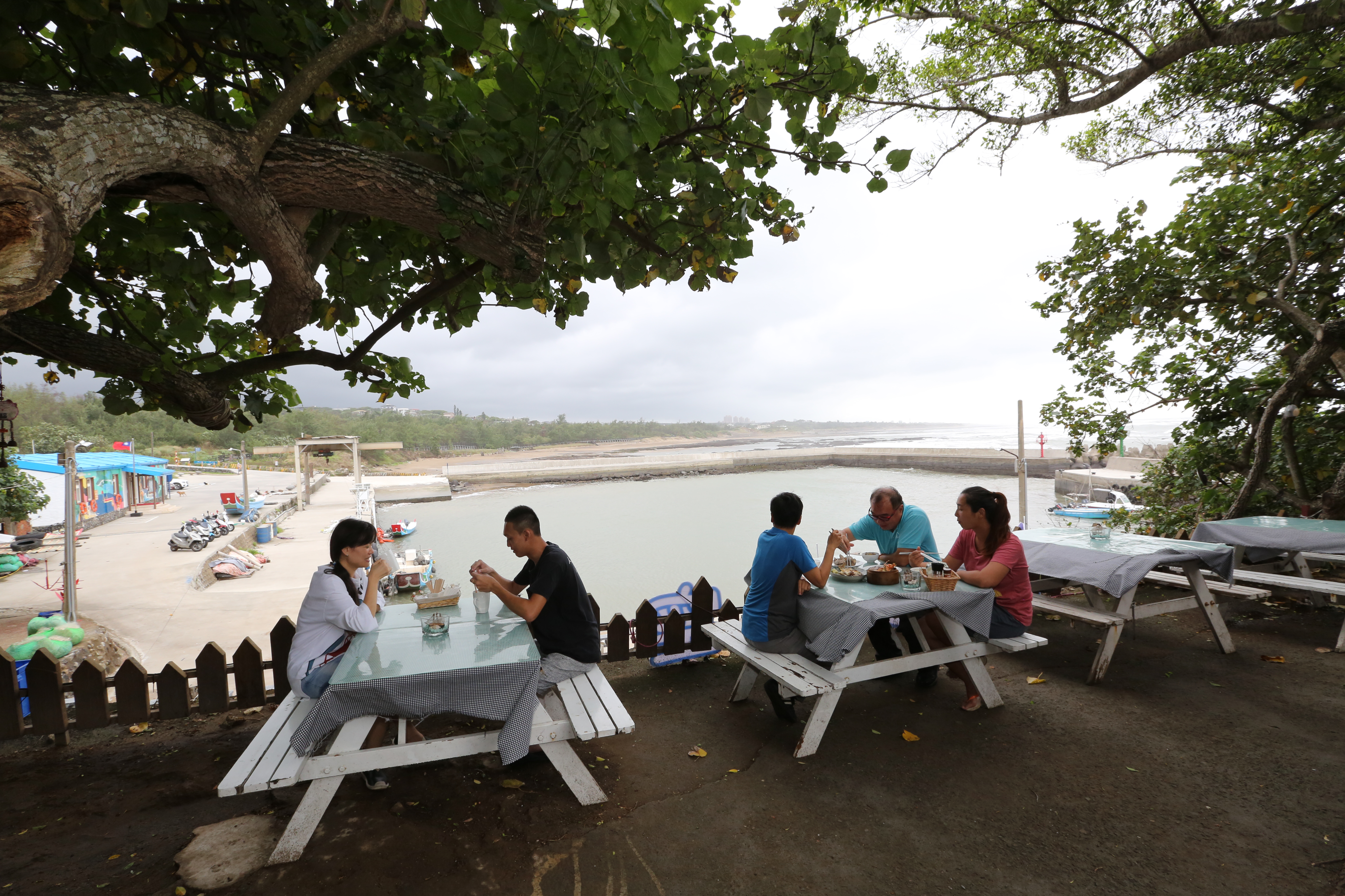 坐在新北市石門海邊吃海鮮，獨享小漁港風光。