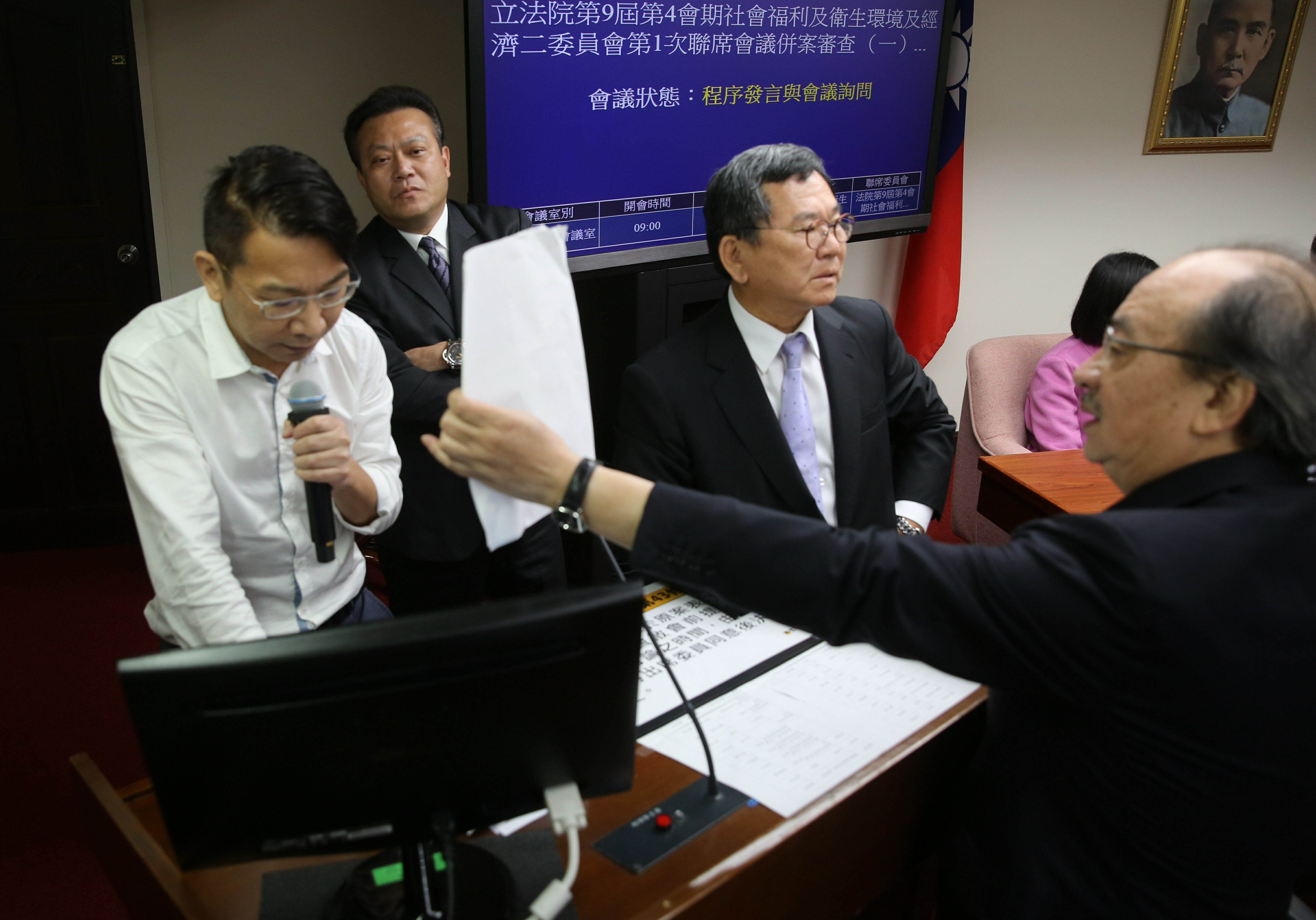 時代力量立委徐永明（左）今會議不斷霸佔發言台，不讓會議進行。