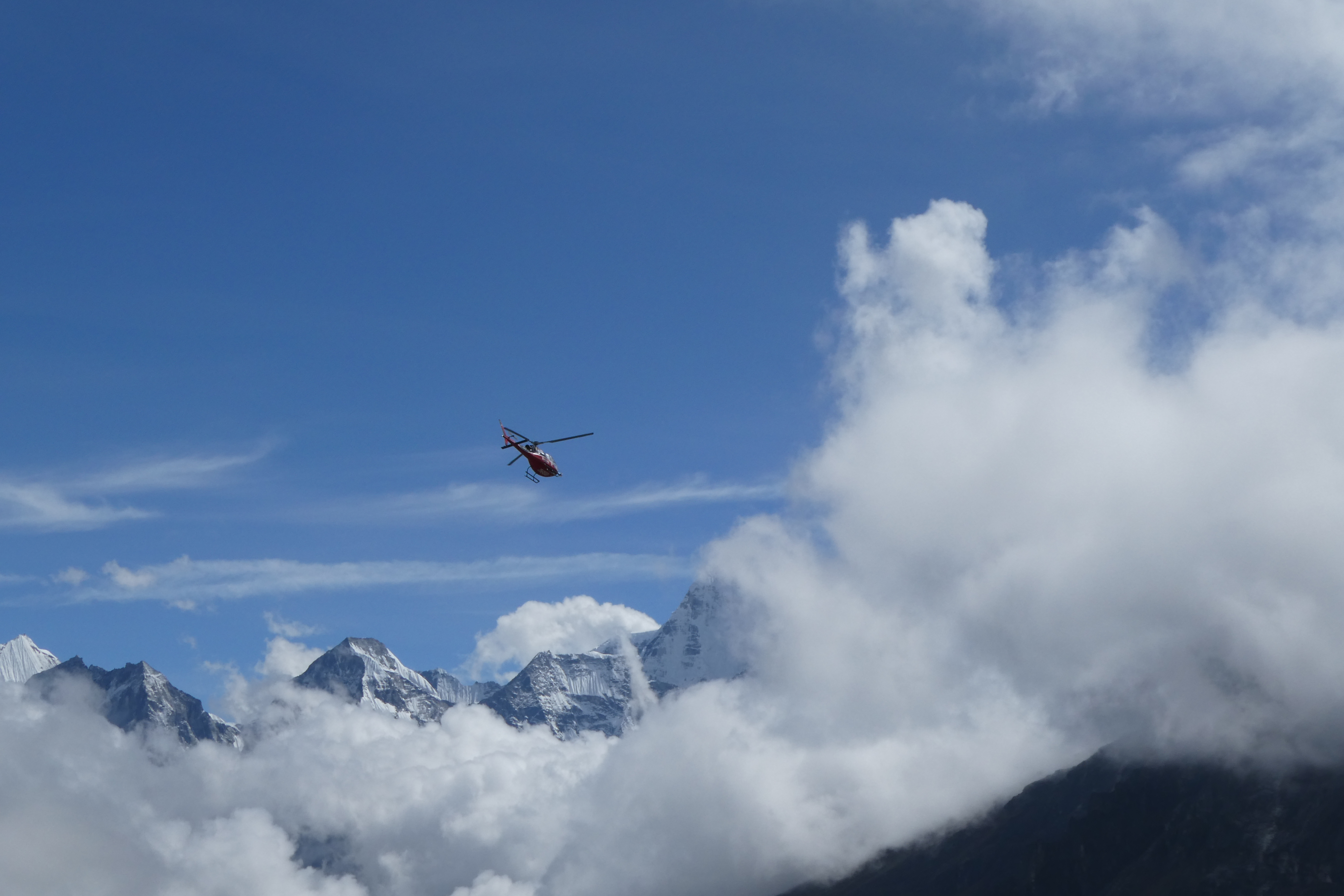 直升機受天候影響，小心翼翼行駛於雪峰之間。