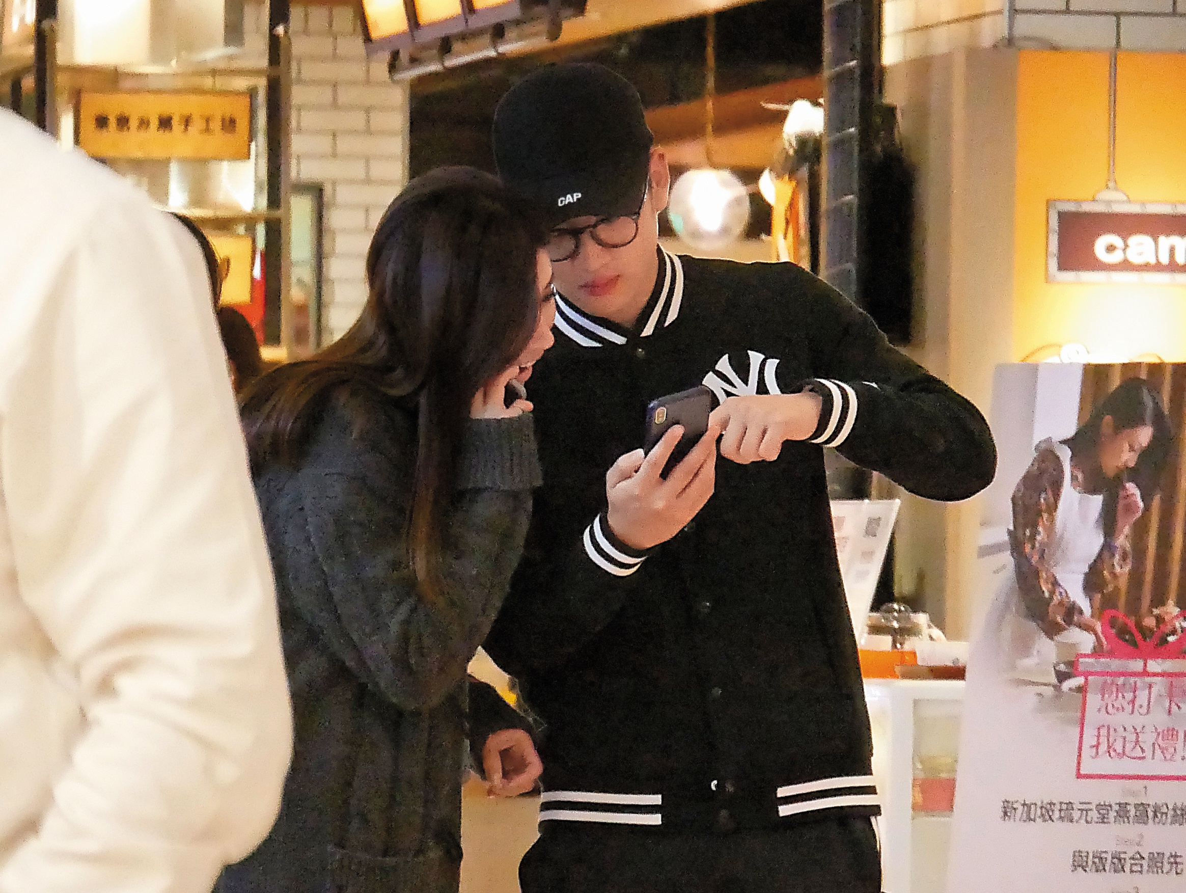 2/21 19:25 本刊直擊，周興哲帶著新女友逛百貨公司地下街，動作親暱。