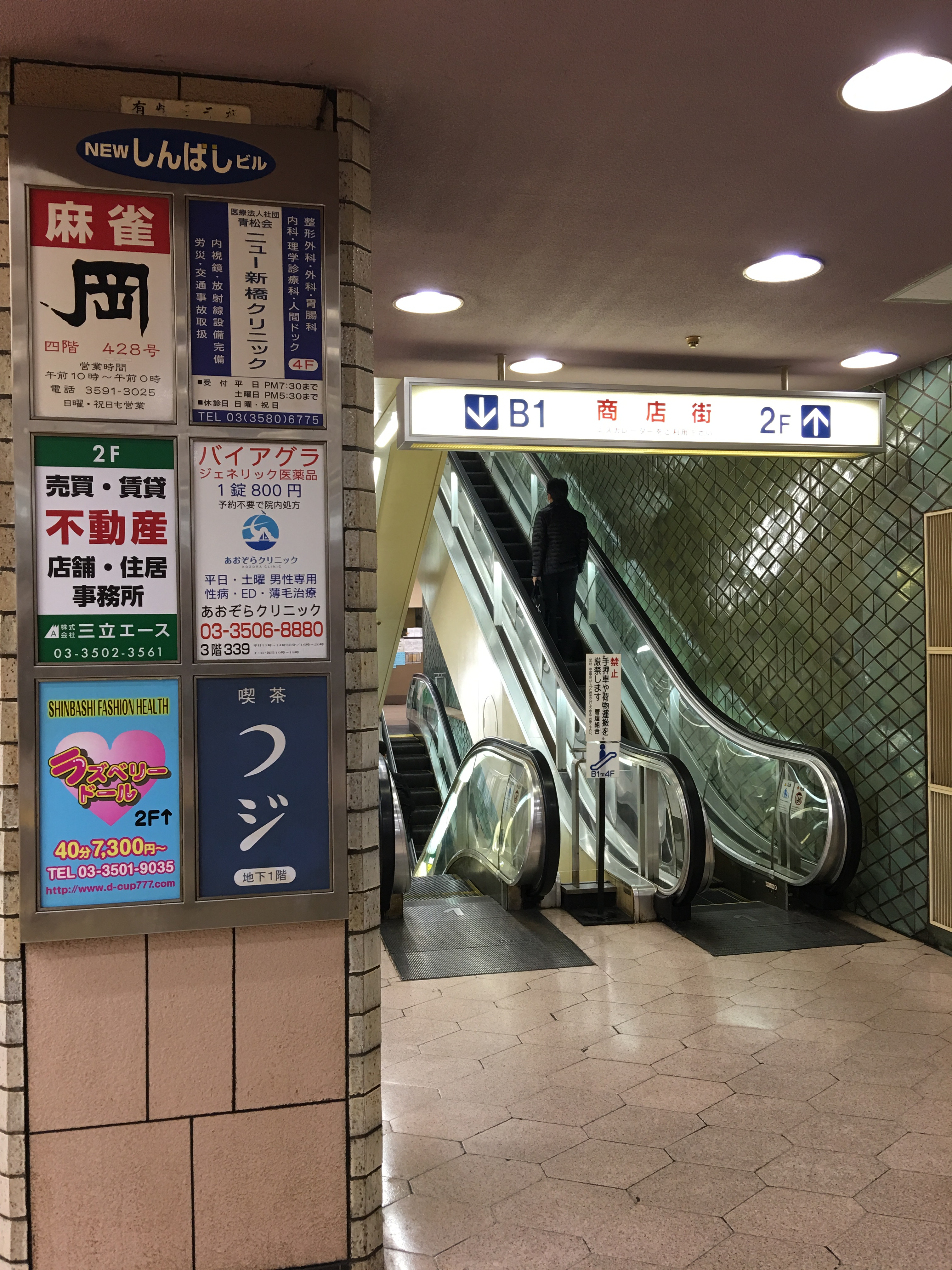 「New新橋大樓」入口看板廣告，從「麻將」、「威而鋼」到「Fashion Health」情色服務，內容五花八門，反映其早年黑市遺址的作風。