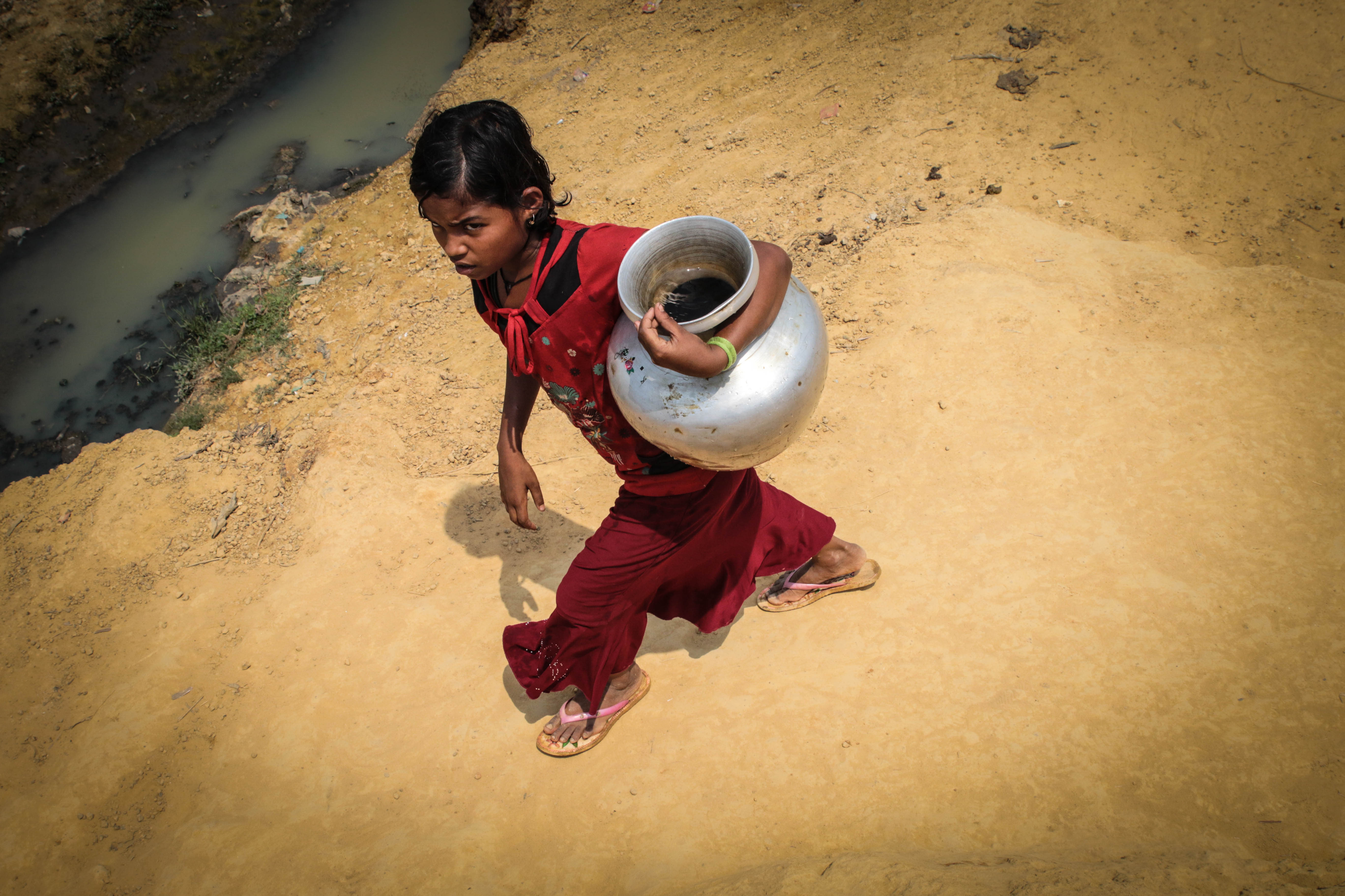 打水後返回難民營的羅興亞女孩。（東方IC）
