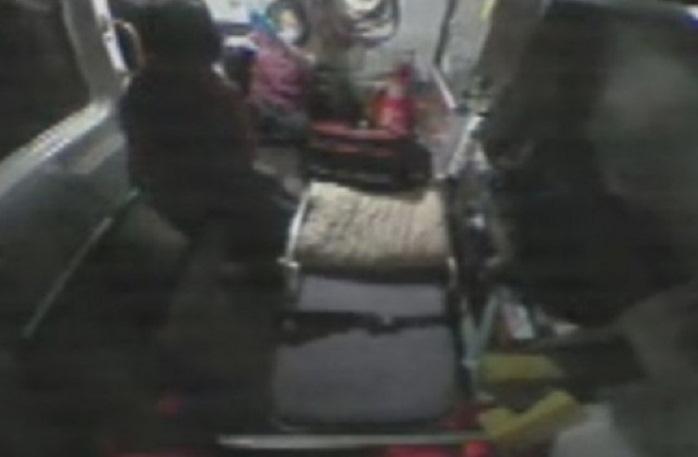 劉女（站者）在救護車上，突對女救護員施暴，女救護員僅出手抵擋，並未還手。（消防局提供）
