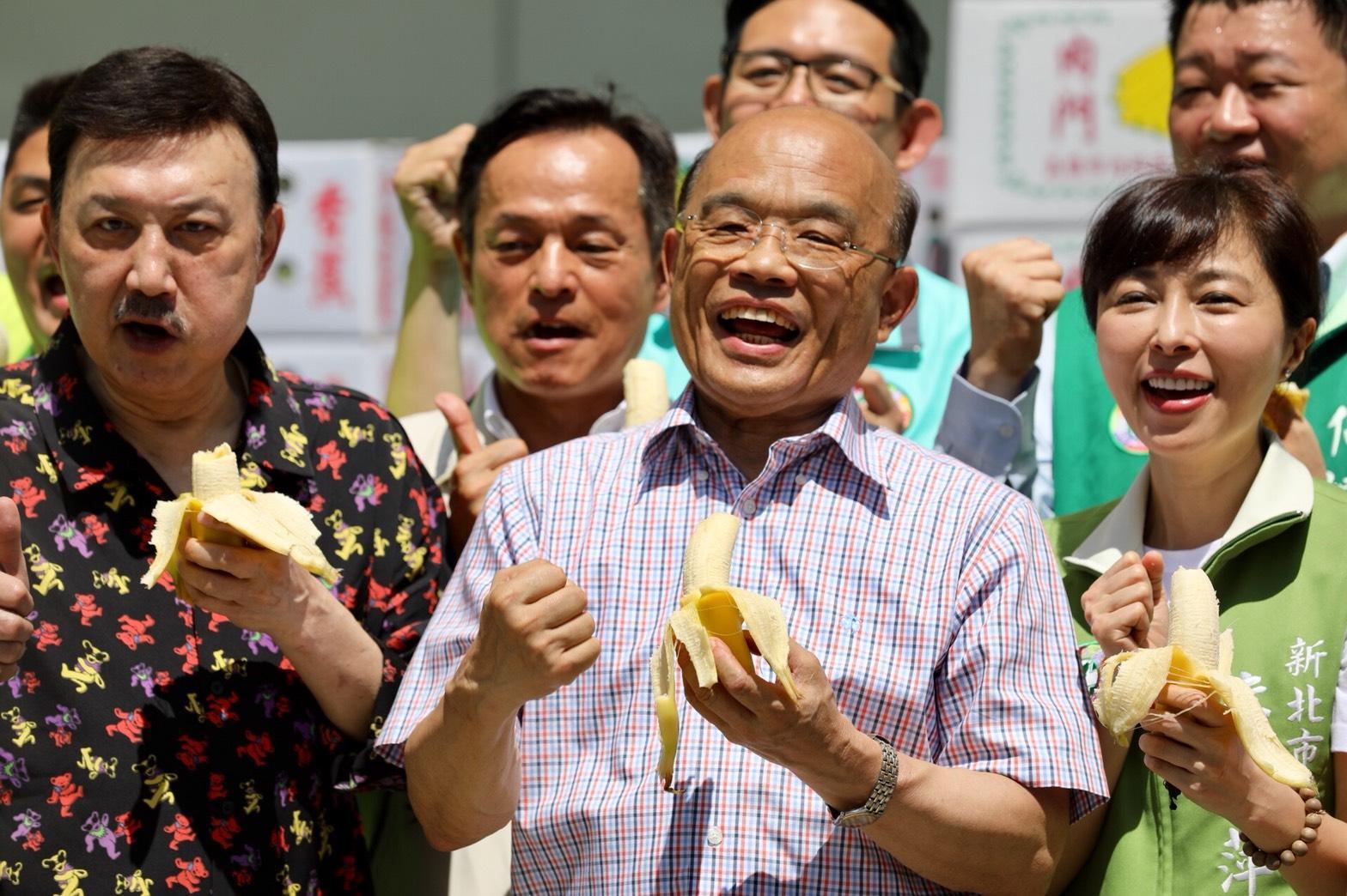 余天(左)今早出席民進黨新北市黨部香蕉推廣活動,與新北市長參選人蘇貞昌及民進黨市議員同台吃香蕉。(蘇貞昌競選辦公室提供)