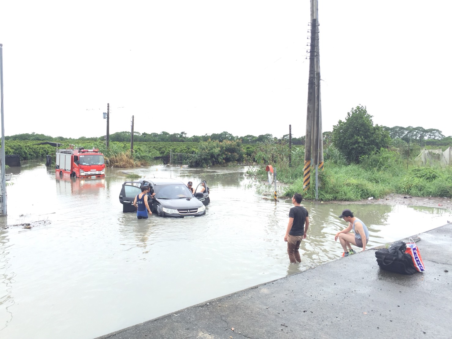 連巡視河川的公務車也成了受災戶，受困於積水中。（警消提供）