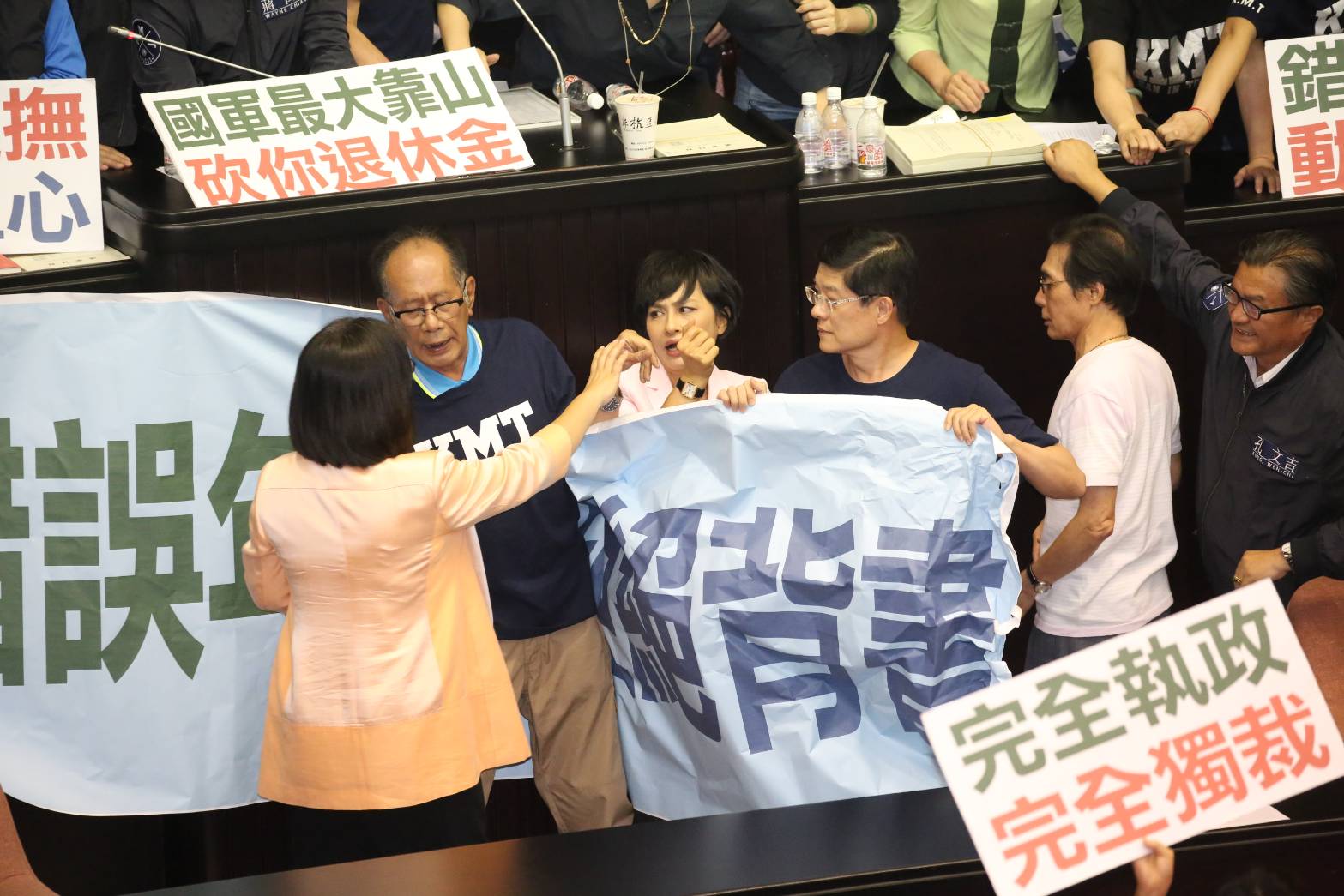 綠委邱議瑩欲扯下國民黨團的海報，與藍委陳超明、羅明才拉扯。