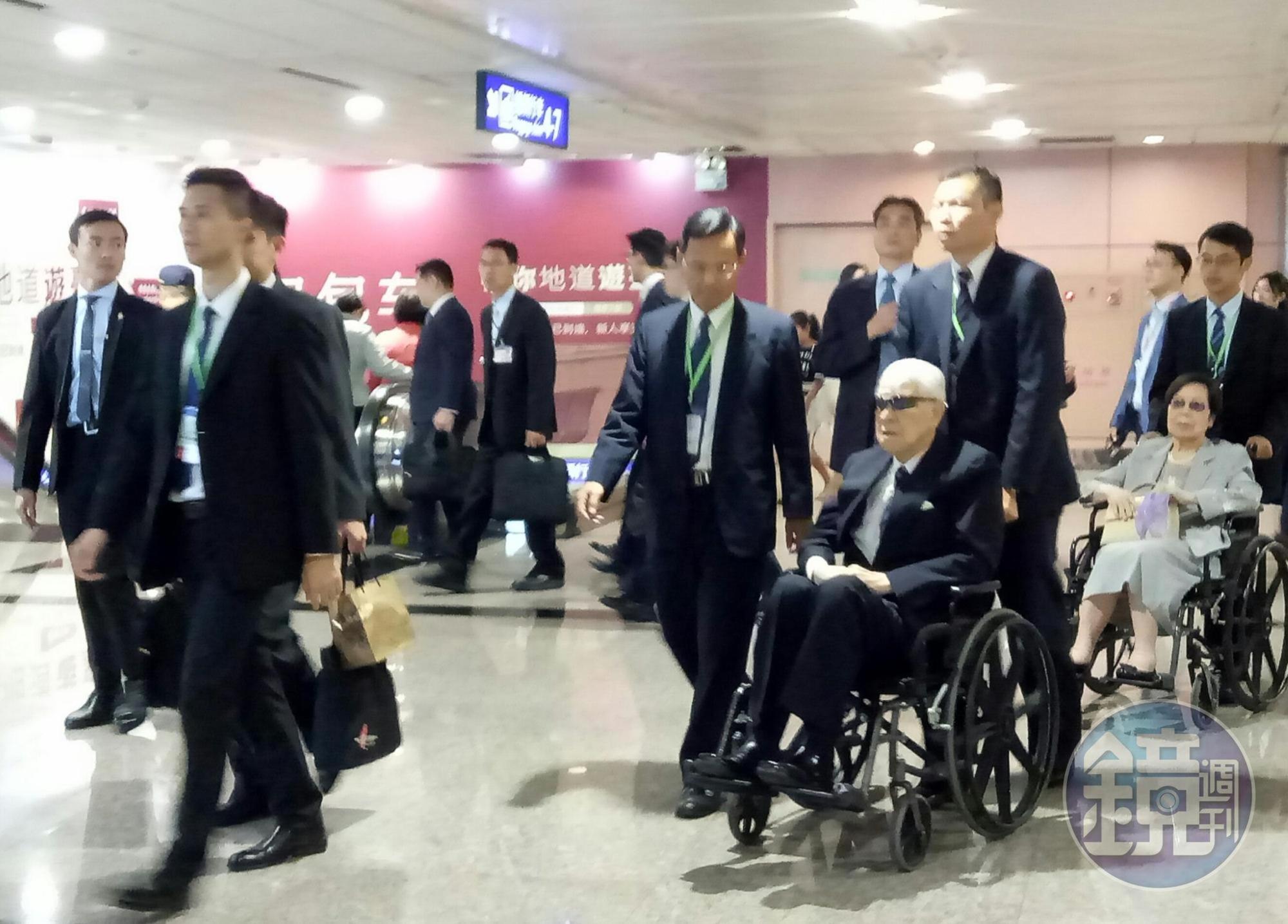 前總統李登輝與夫人曾文惠今返抵桃園機場,在機場2人坐上輪椅由隨扈推著通關。
