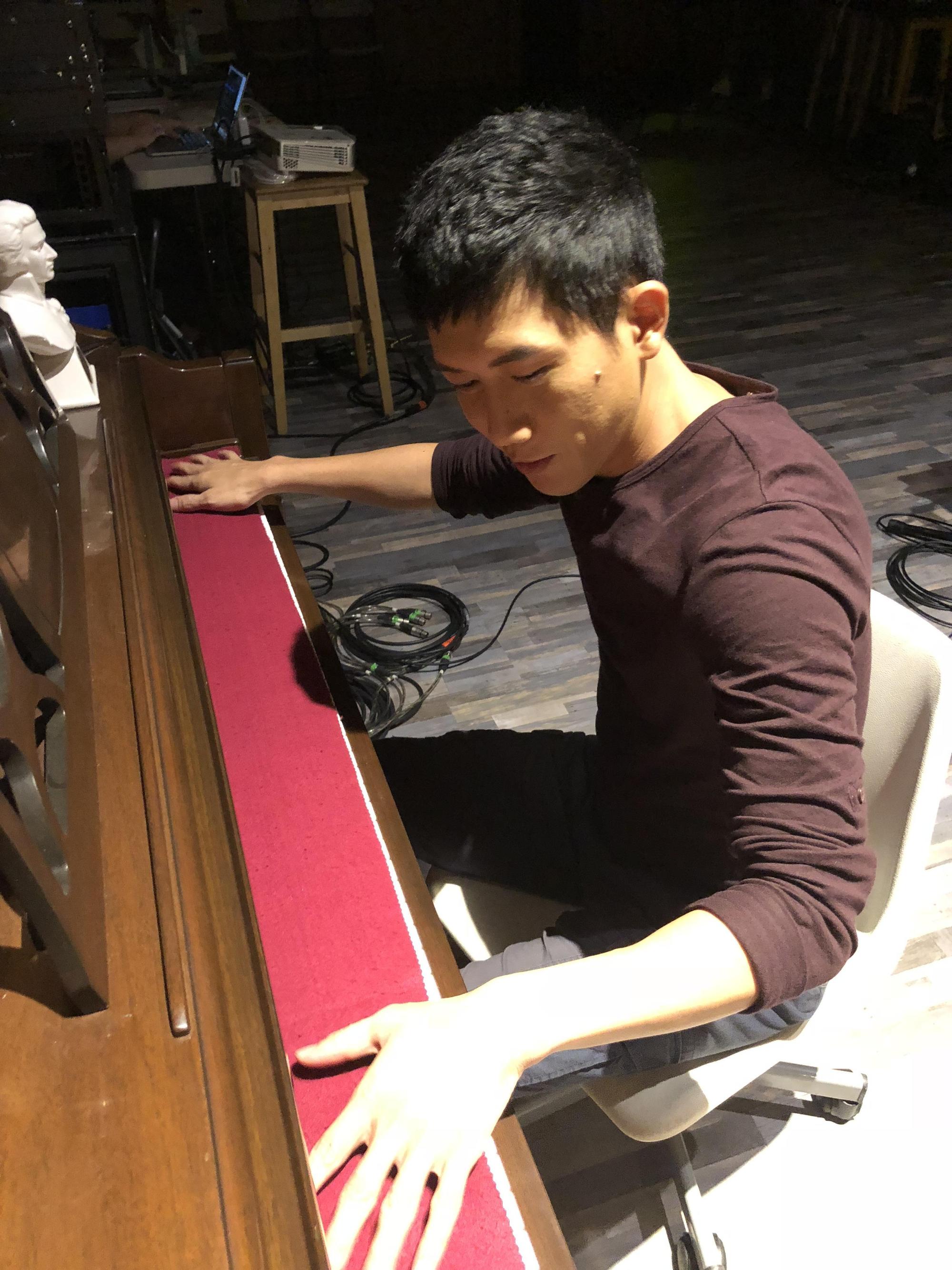 莫子儀不拿開鋼琴蓋布,憑手指記憶觸感彈琴,讓教他琴藝的黃裕翔很滿意。(有享影業提供)