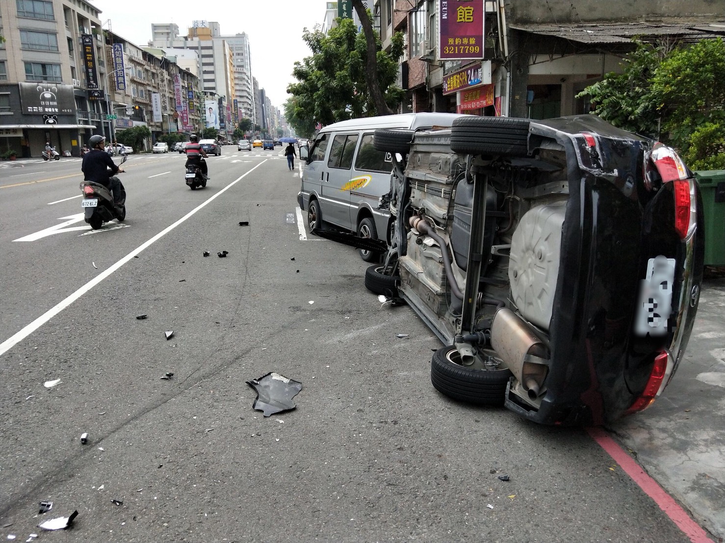 黑車被撞翻，毀損嚴重，車上兩個男子還被對方持球棒毆傷。（警方提供）
