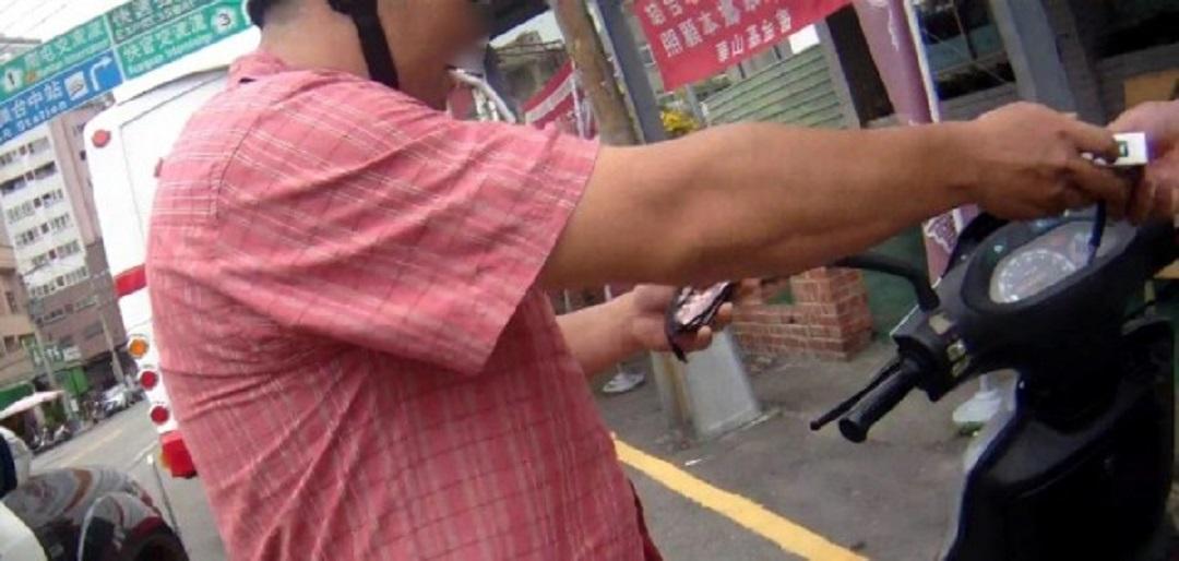 黃男被警方攔查,因心虛急忙抽起菸來紓緩緊張(警方提供)