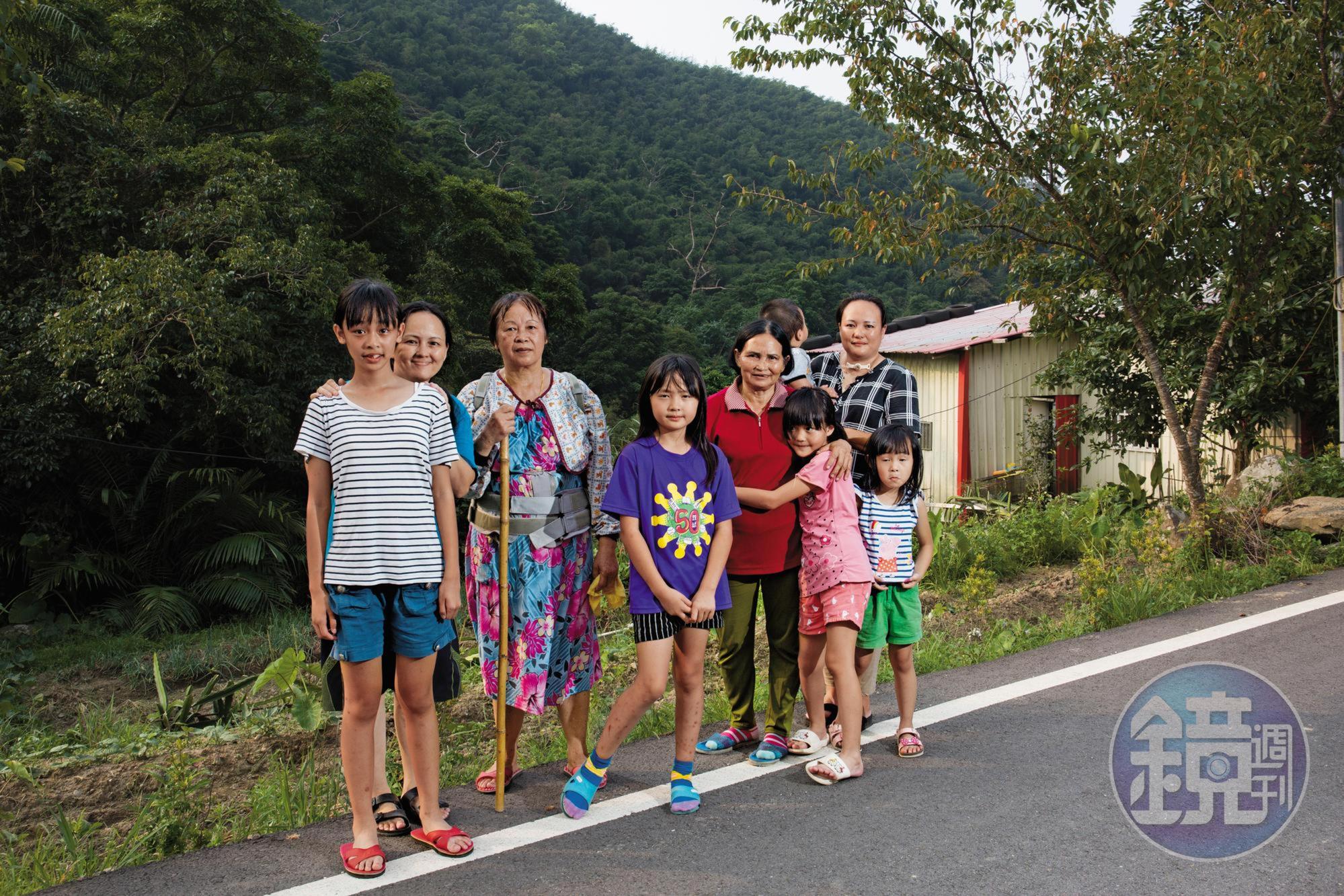 邱雅詩（紫衣）、邱雅霓（粉紅衣）姊妹平時由姑姑、奶奶照顧，右後方的鐵皮屋就是她們的家。