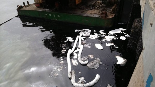 台中港碼頭遭油汙汙染，港務分公司以吸油棉防堵。（港務公司提供）