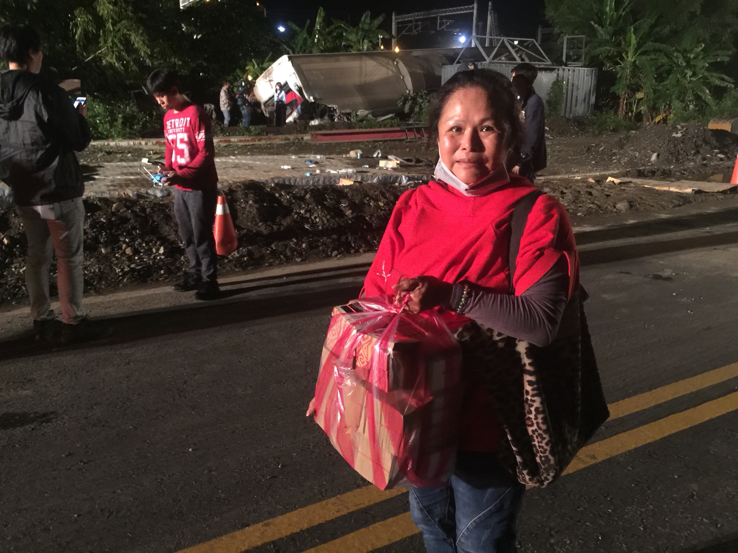 婦人帶著大捆金紙回到現場，希望能撫慰亡者，也為傷者祈福。