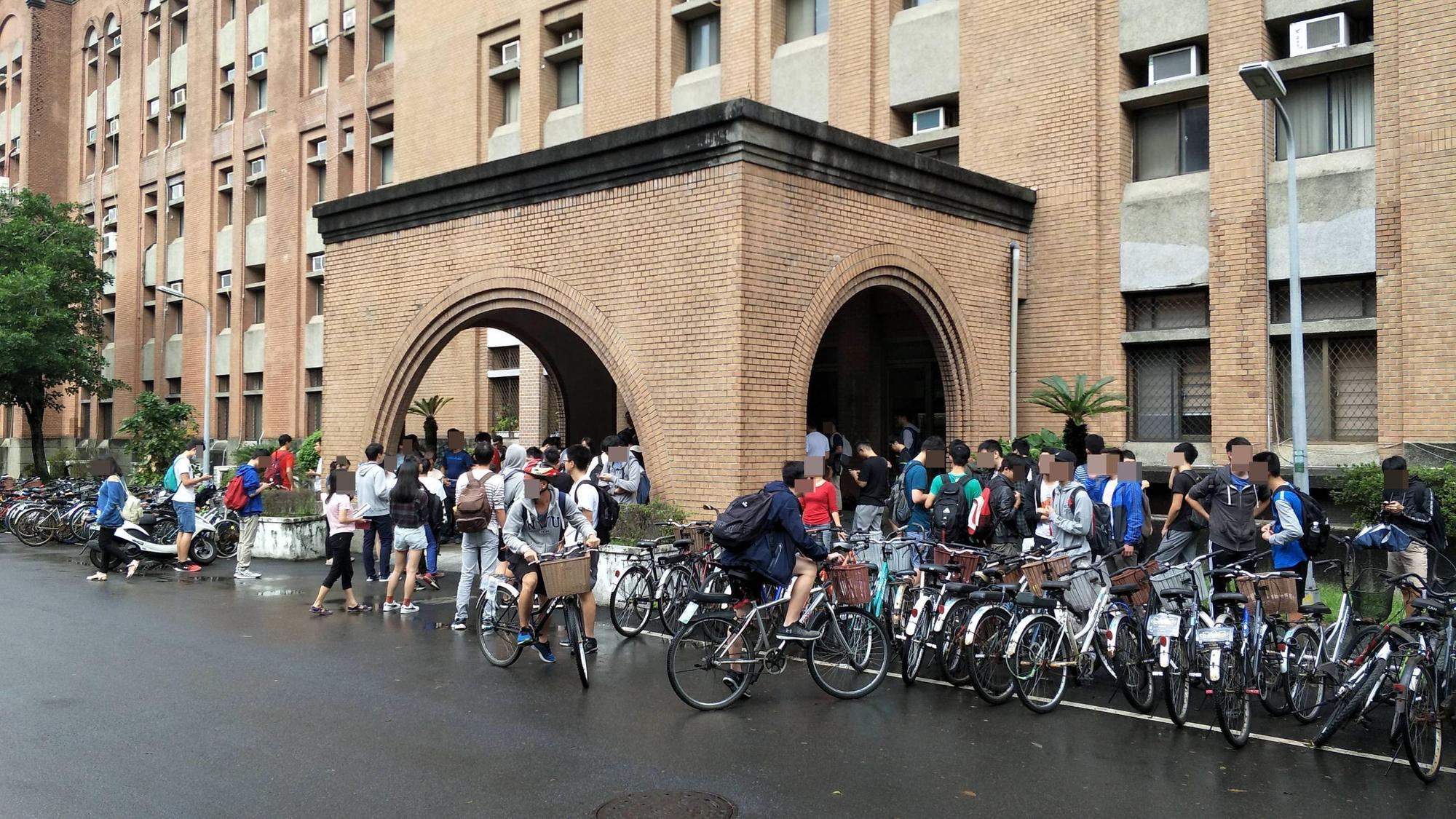 正在進行期中考台大電機二館,疑因傳出砷化氫外洩而疏散師生,圖為學生湧出圖。(翻攝自hilarious)