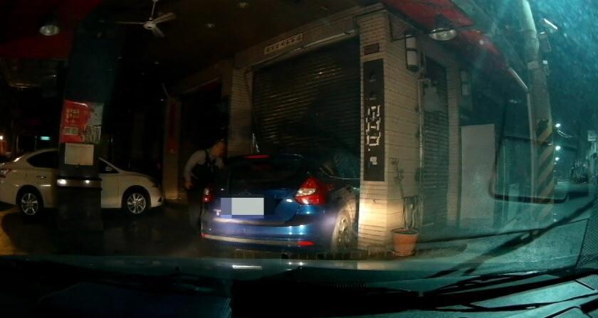 藍色轎車見警攔查加速逃逸，失控撞民宅鐵門。（警方提供）