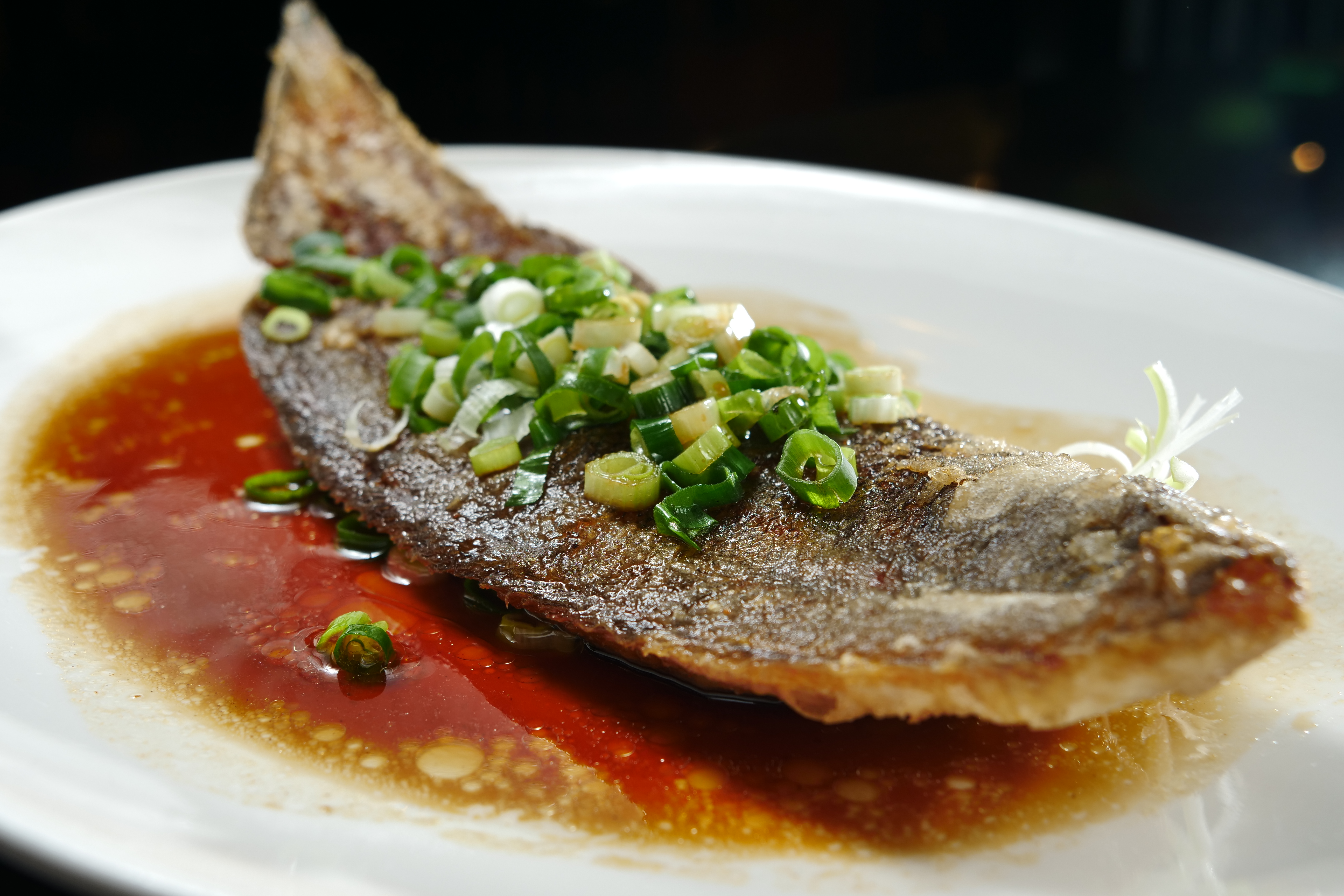 用粵式作法烹煮的「煎封比目魚」，魚皮酥脆，魚肉白皙帶油香，蘸著醬汁更夠味。（時價，圖中約420元）