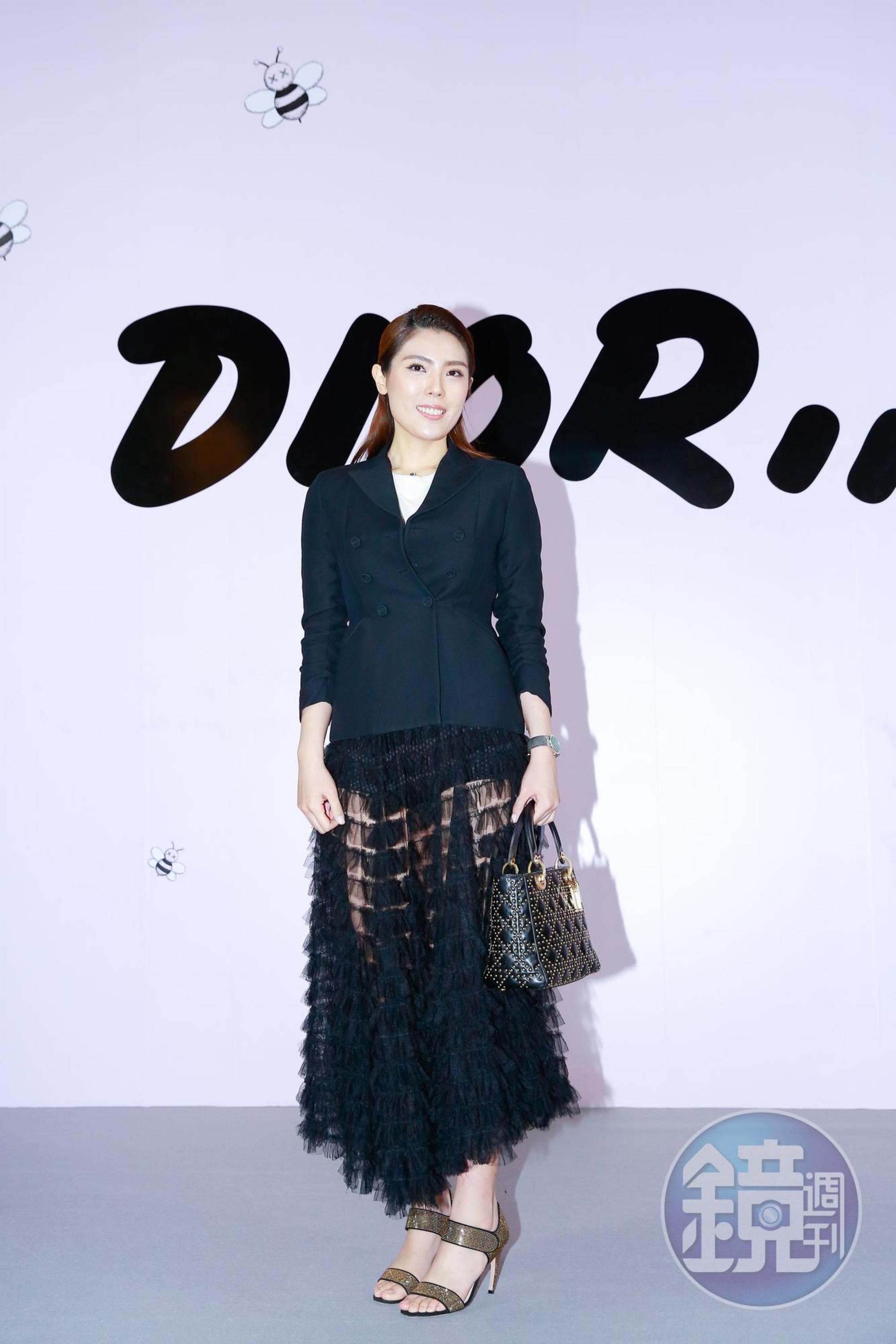 理科太太穿著Dior黑色Bar Jacket,NT$145,000;黑色透明蛋糕紗裙,NT$340,000;白色棉T,NT$24,000;黑色運動內襯褲,NT$32,000。