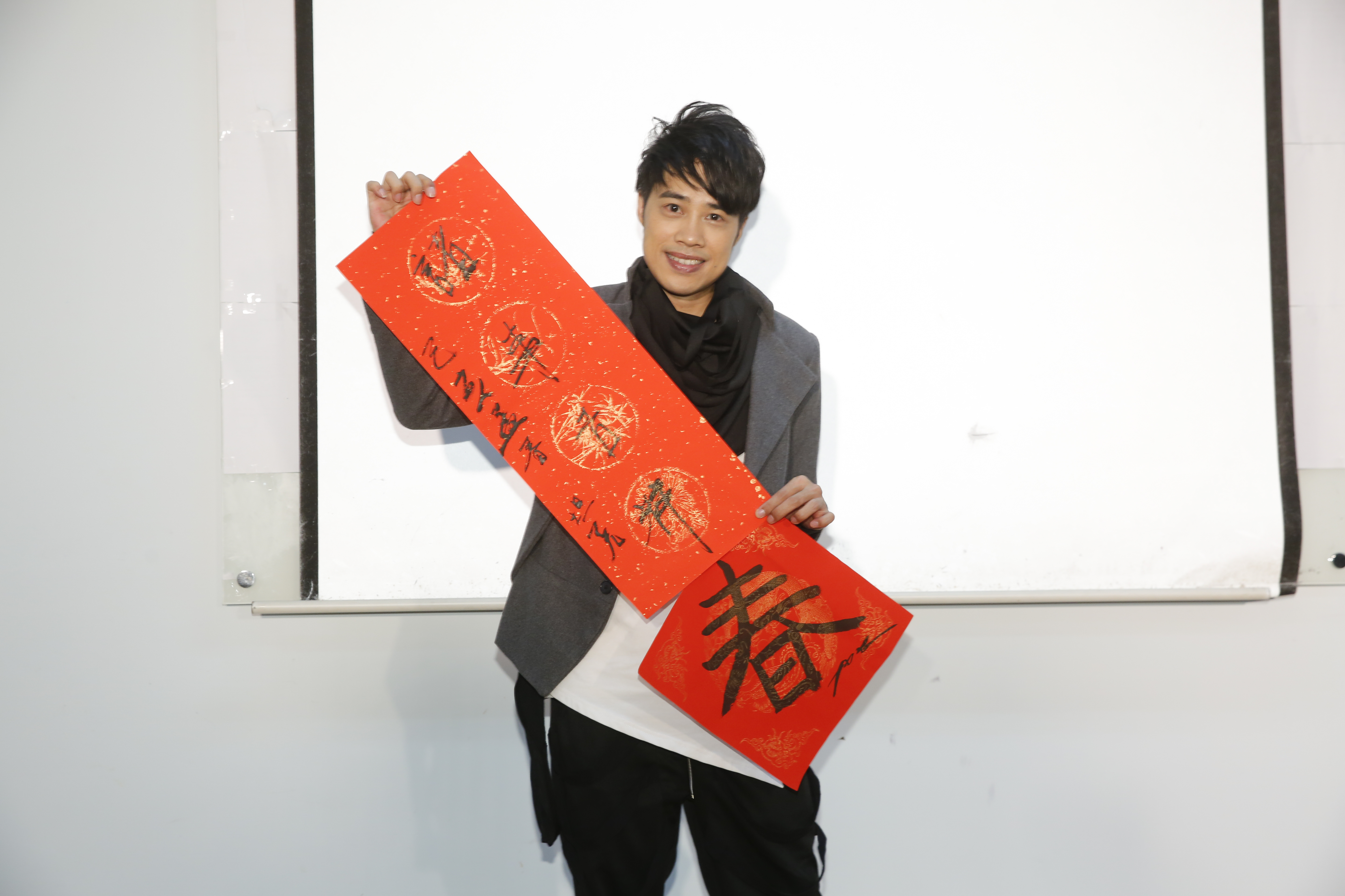 重返歌壇的TANK當志工，陪著長輩寫春聯提前過節。