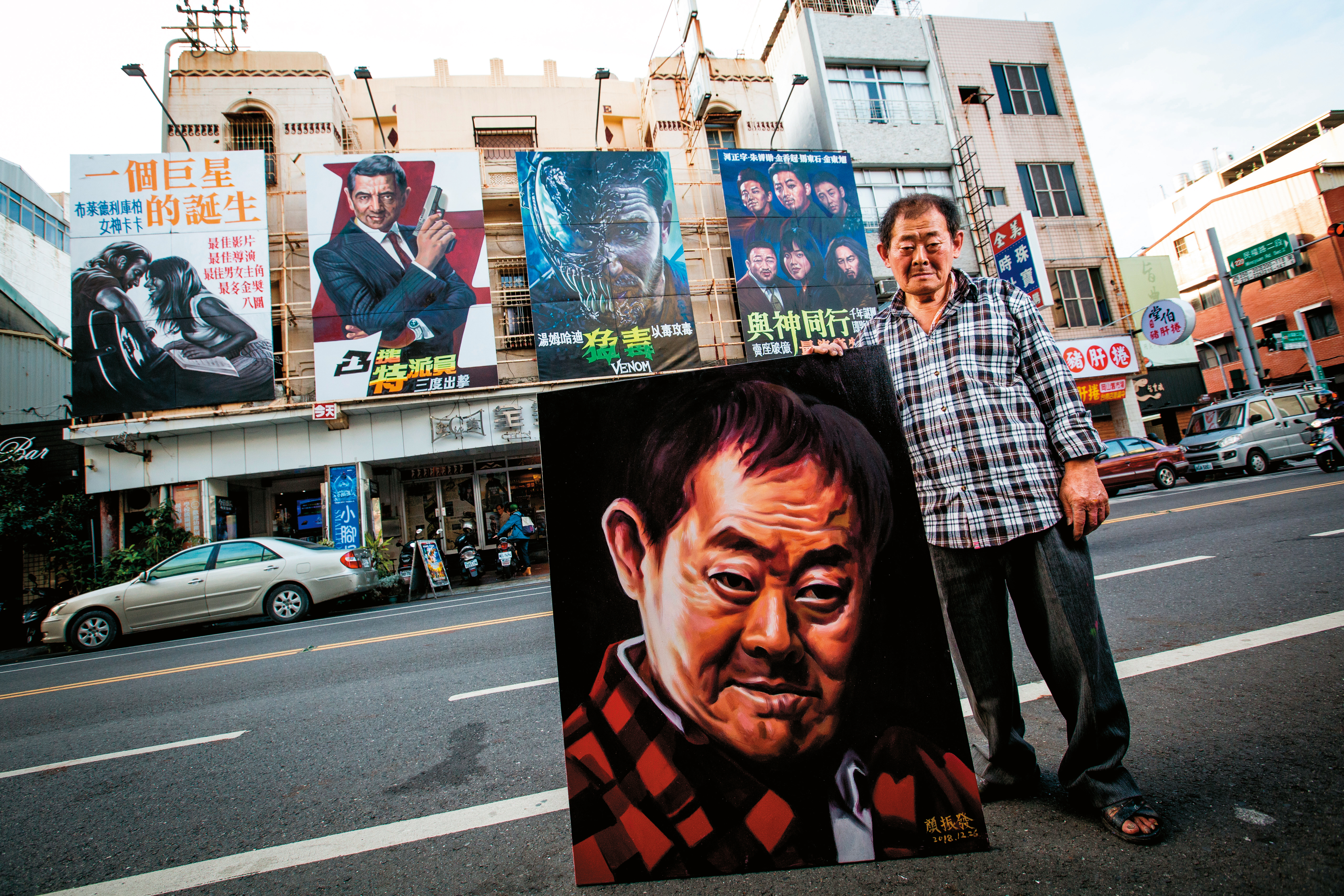 走紅國內外後，顏振發近年畫了幾幅自畫像，這張是最近所畫。他所站後方即是全美戲院。