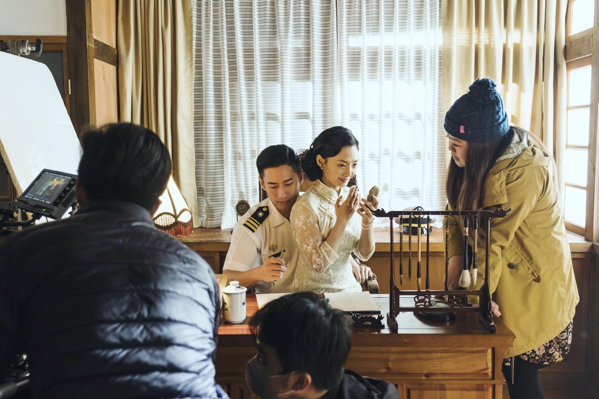 導演謝庭菡(右)指導「過去」時空場景中,舞廳小姐(中)與海軍少校軍官(左)的感情戲。(公視提供)
