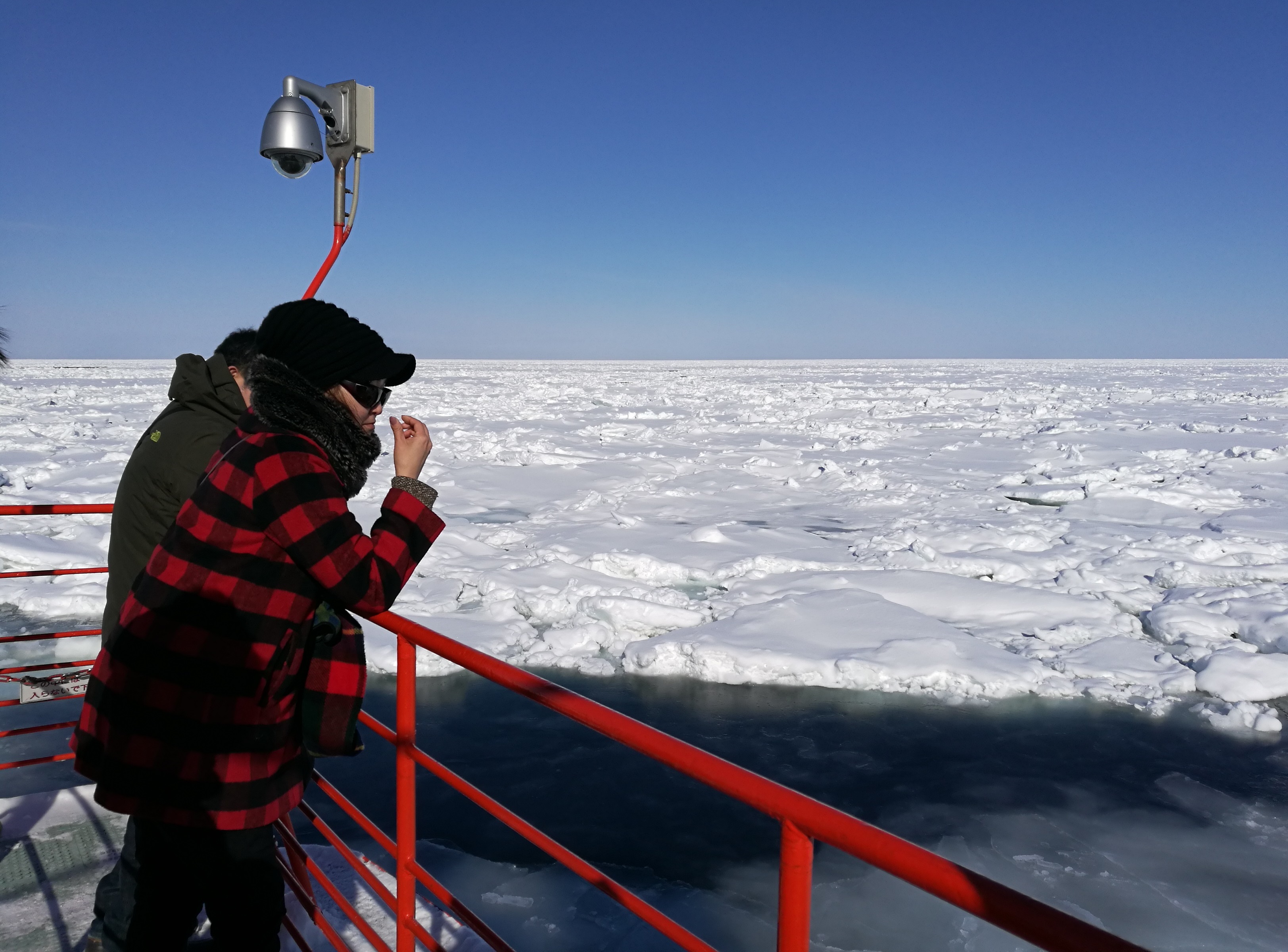 遊客不畏寒風，在甲板欣賞一年一度的流冰奇景。 