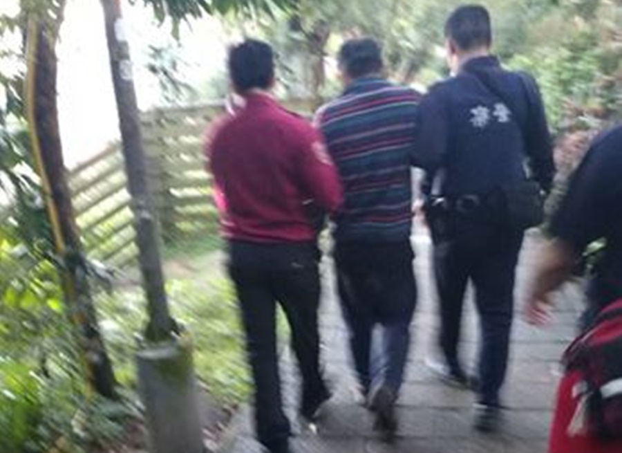 警員黃鴻鈞、劉亦修將謝男攙扶下山後送救護車至北醫就醫。（翻攝畫面）