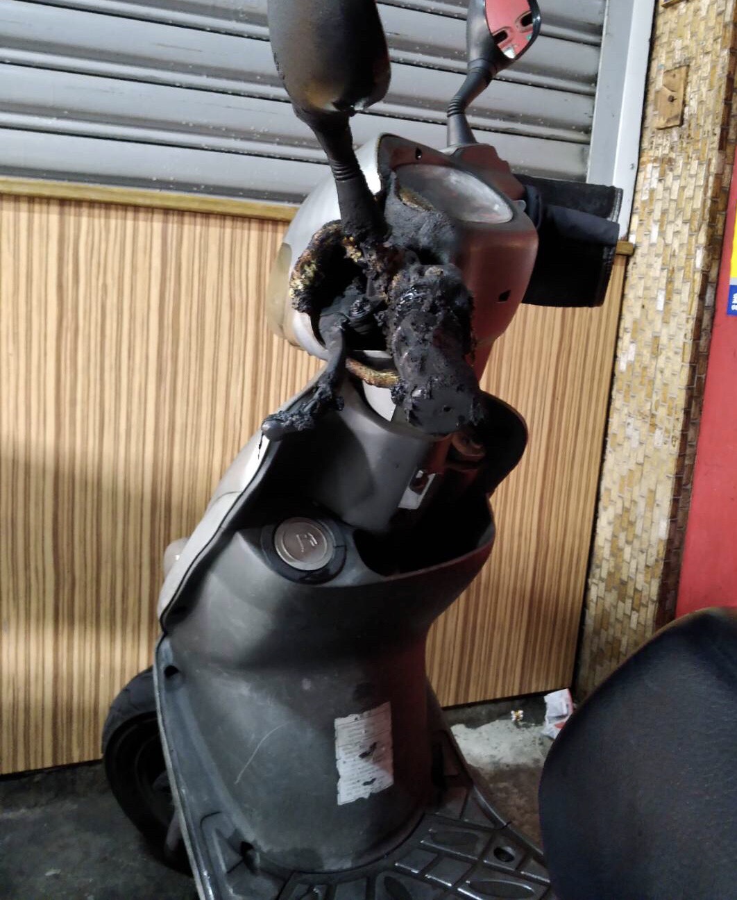 機車的手把被燒毀，所幸民眾撲滅即時，未釀成大禍。（翻攝畫面）